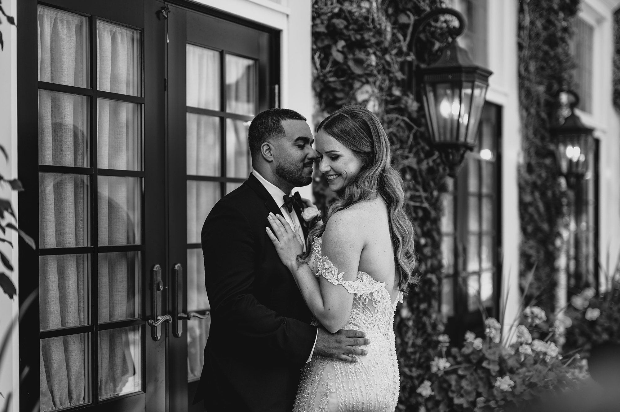 bride and groom hug in front of French doors at David's Country Inn