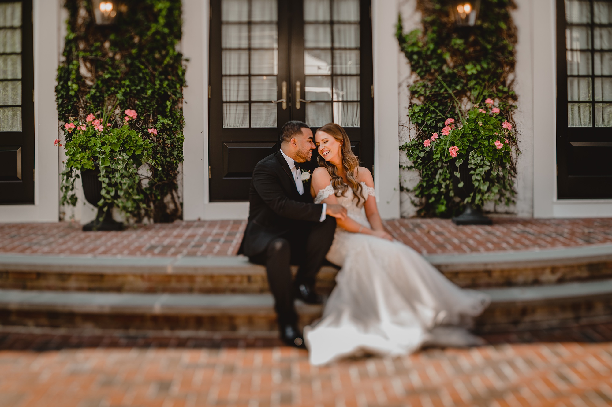 bride and groom hug on steps at David's Country Inn