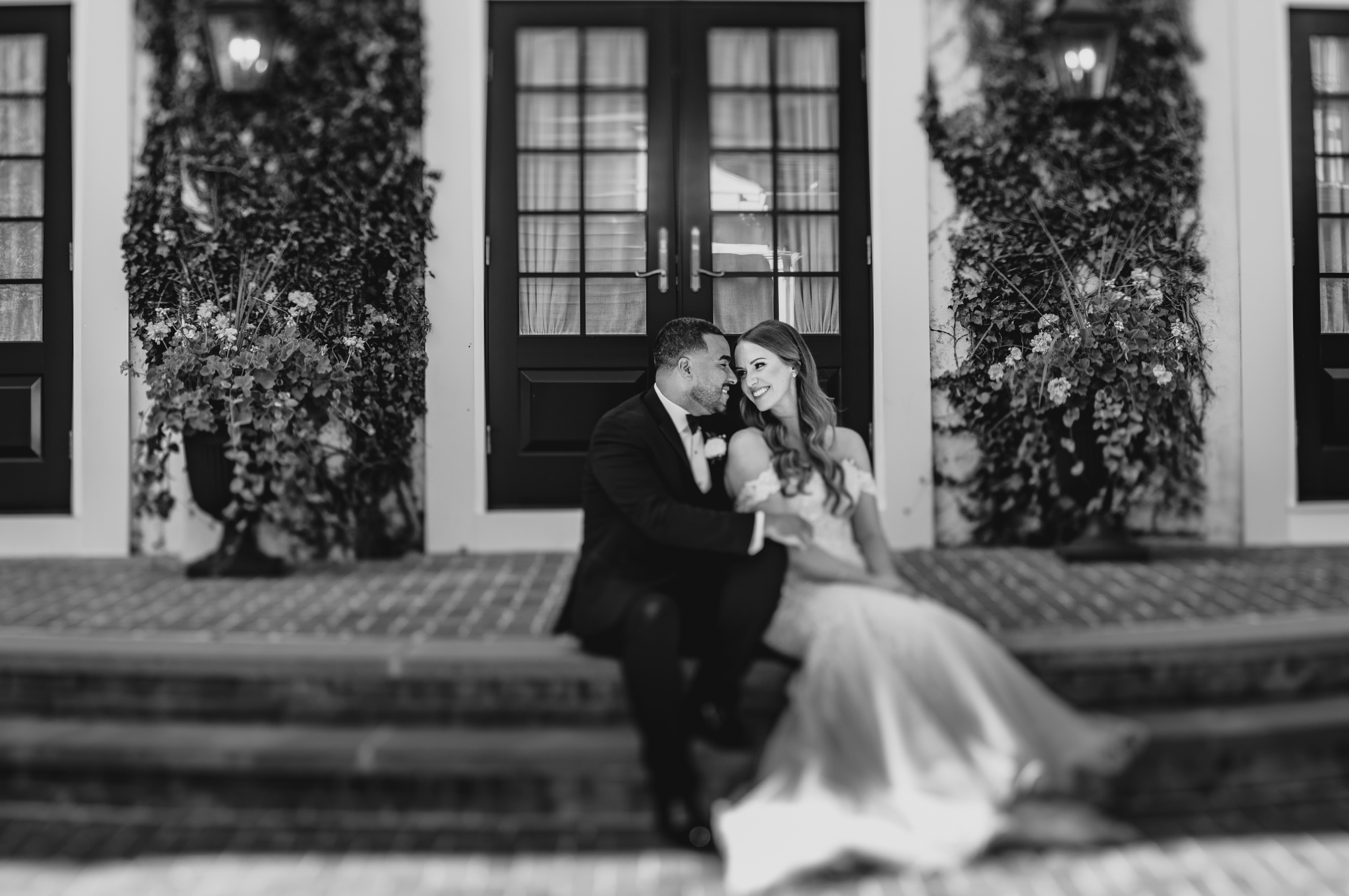 newlyweds sit on brick steps outside David's Country Inn