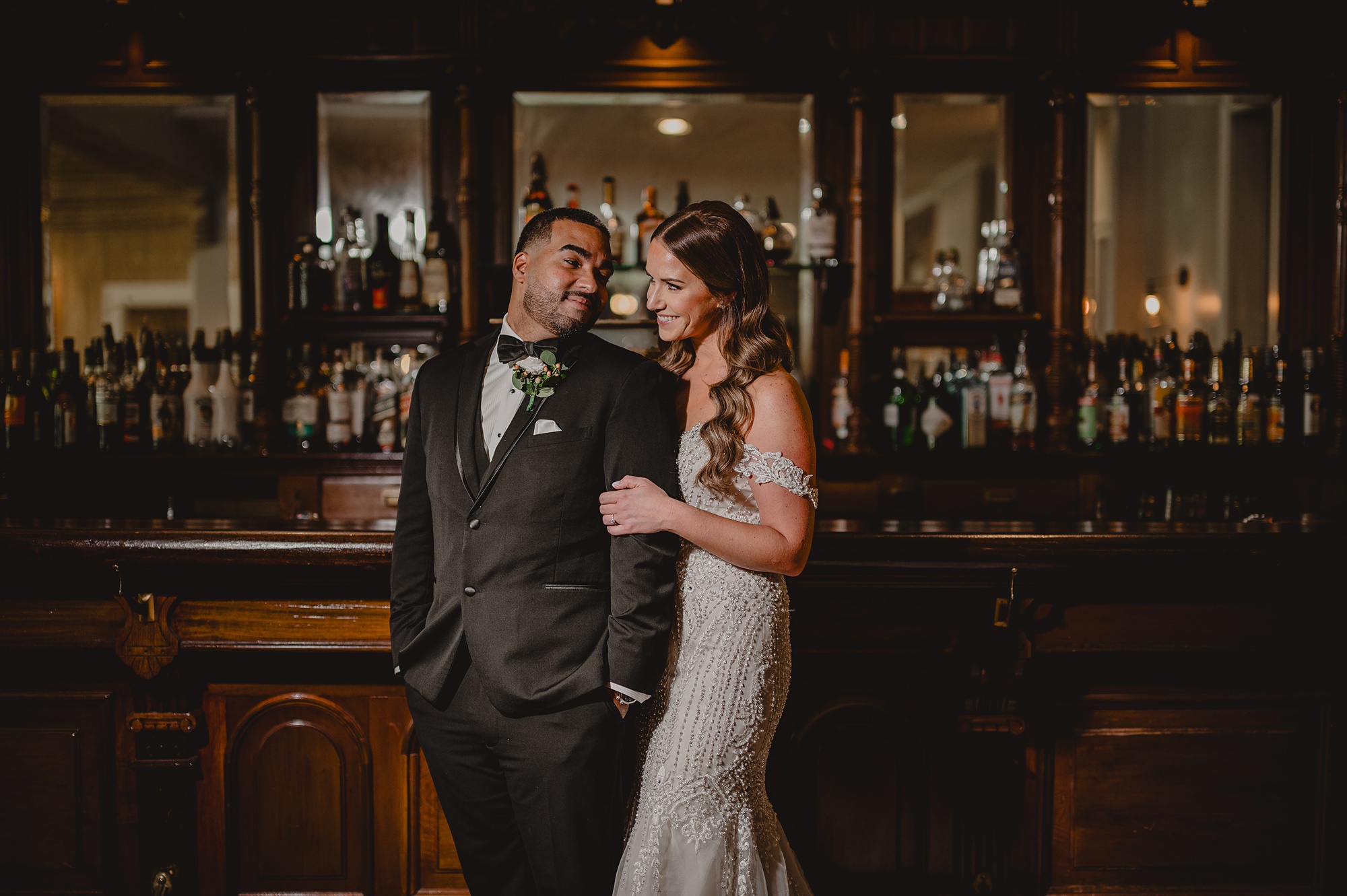 bride hugs groom in front of bar at David's Country Inn