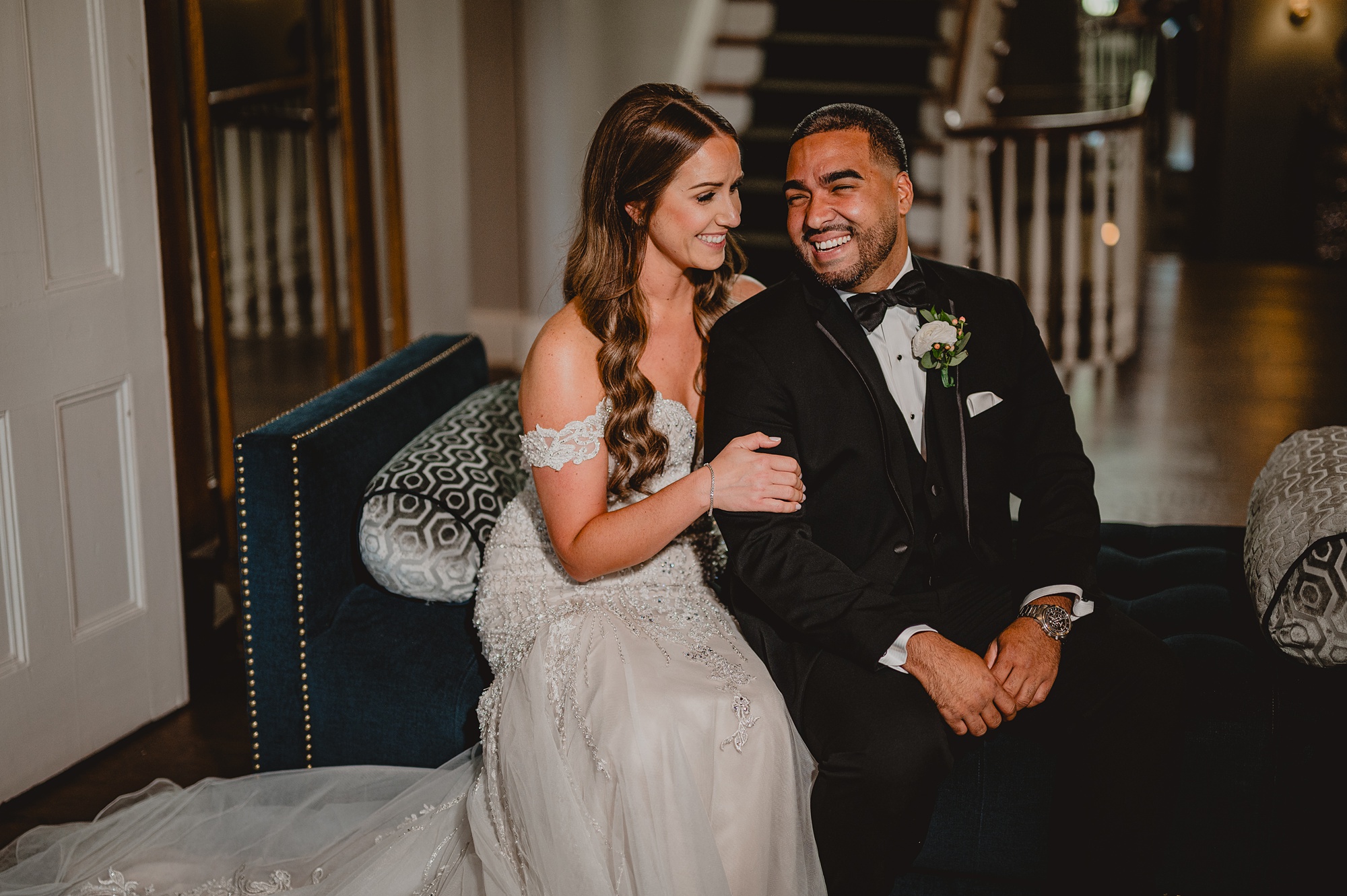 bride and groom sit on parlor furniture at David's Country Inn