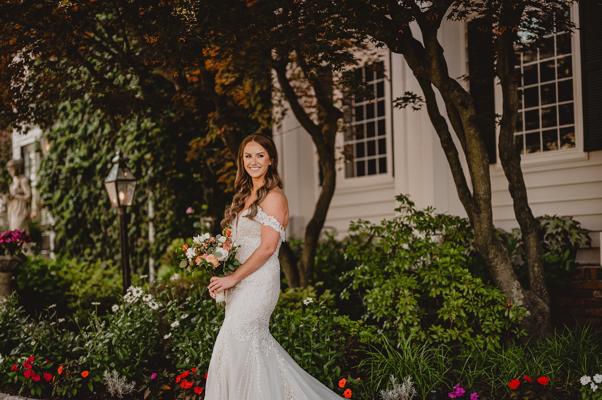 bride holds bouquet of flowers outside garden