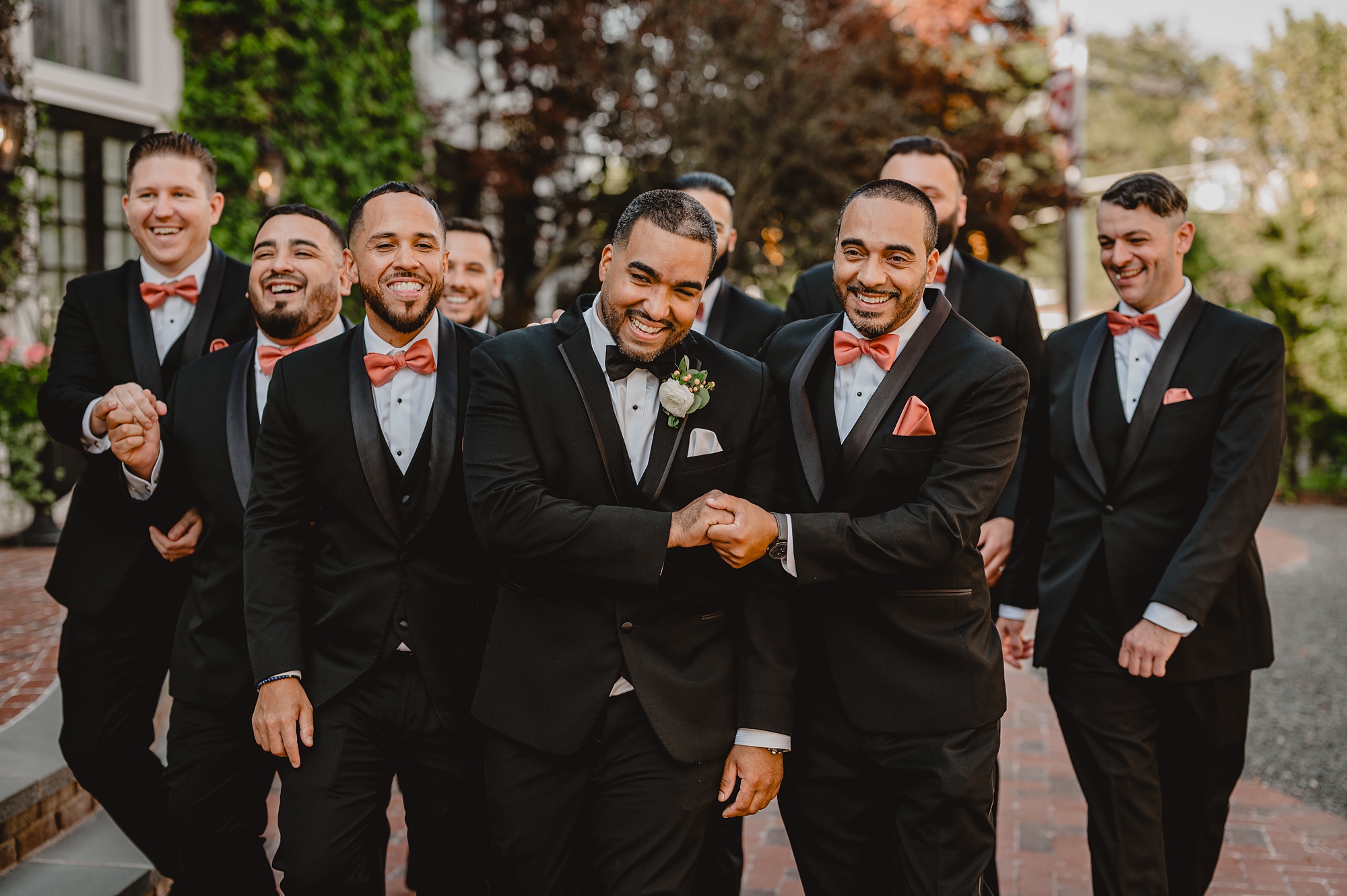 groom shakes hands with groomsmen in front of David's Country Inn