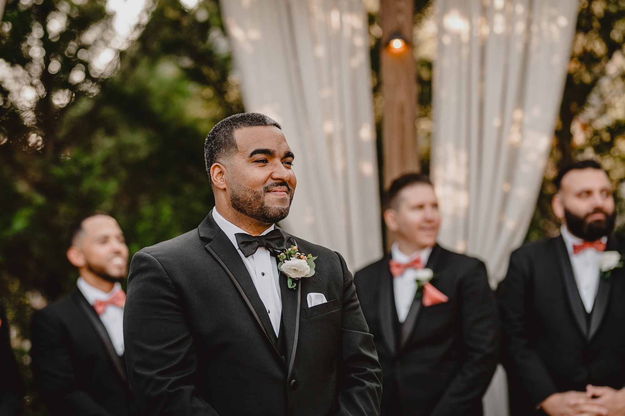 groom watches bride walk aisle at ceremony at David's Country Inn