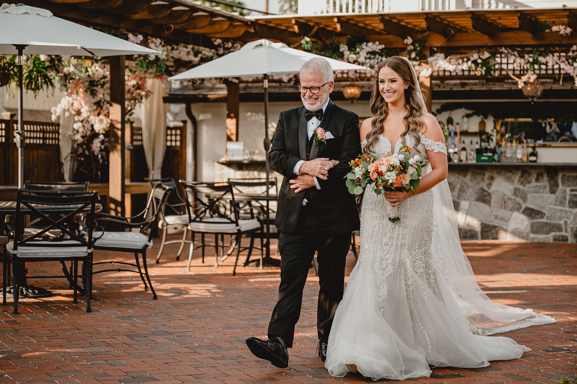 father escorts bride to wedding ceremony on brick patio at David's Country Inn