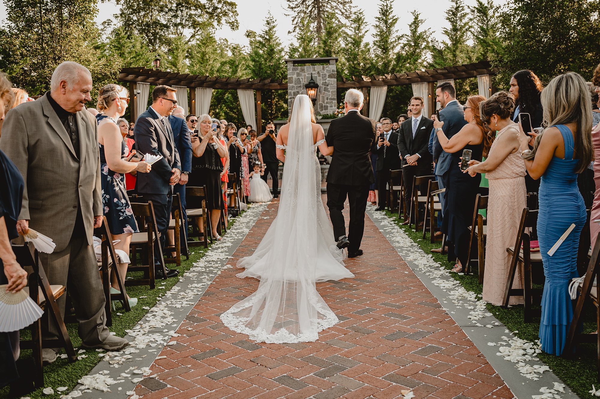 father escorts bride down the aisle for wedding ceremony on brick patio at David's Country Inn