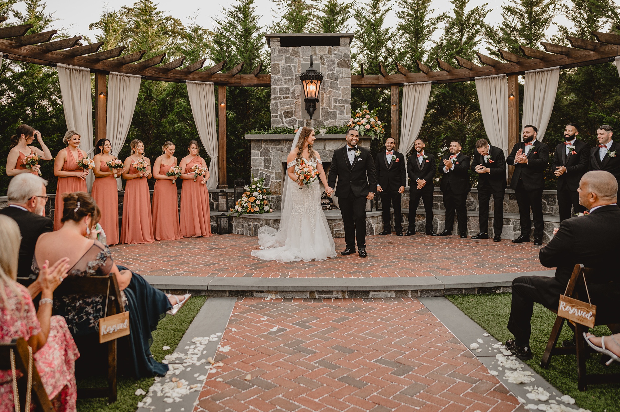 bride and groom hold hands walking down steps from ceremony