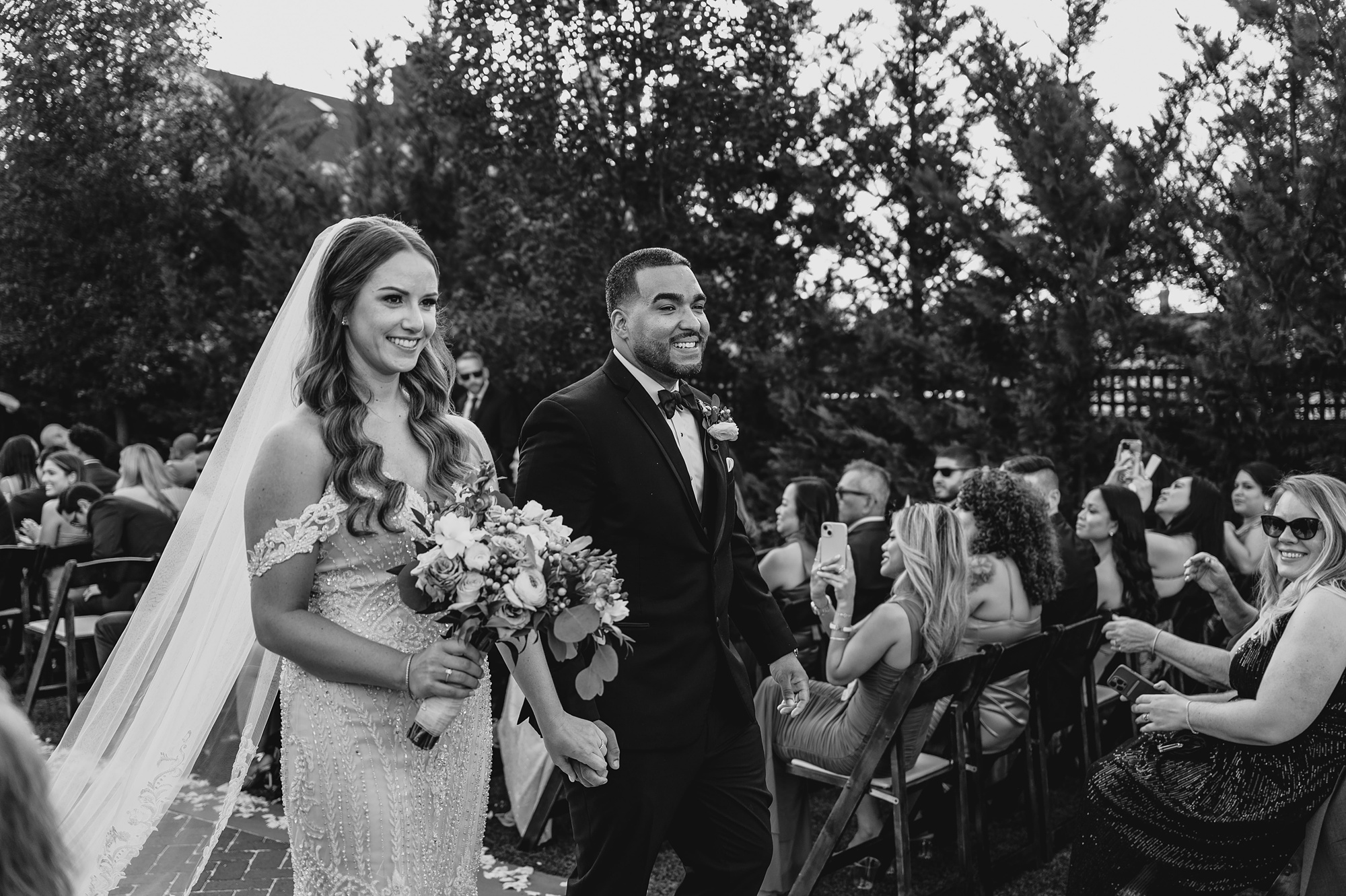 groom and bride walk up aisle at wedding ceremony on brick patio at David's Country Inn