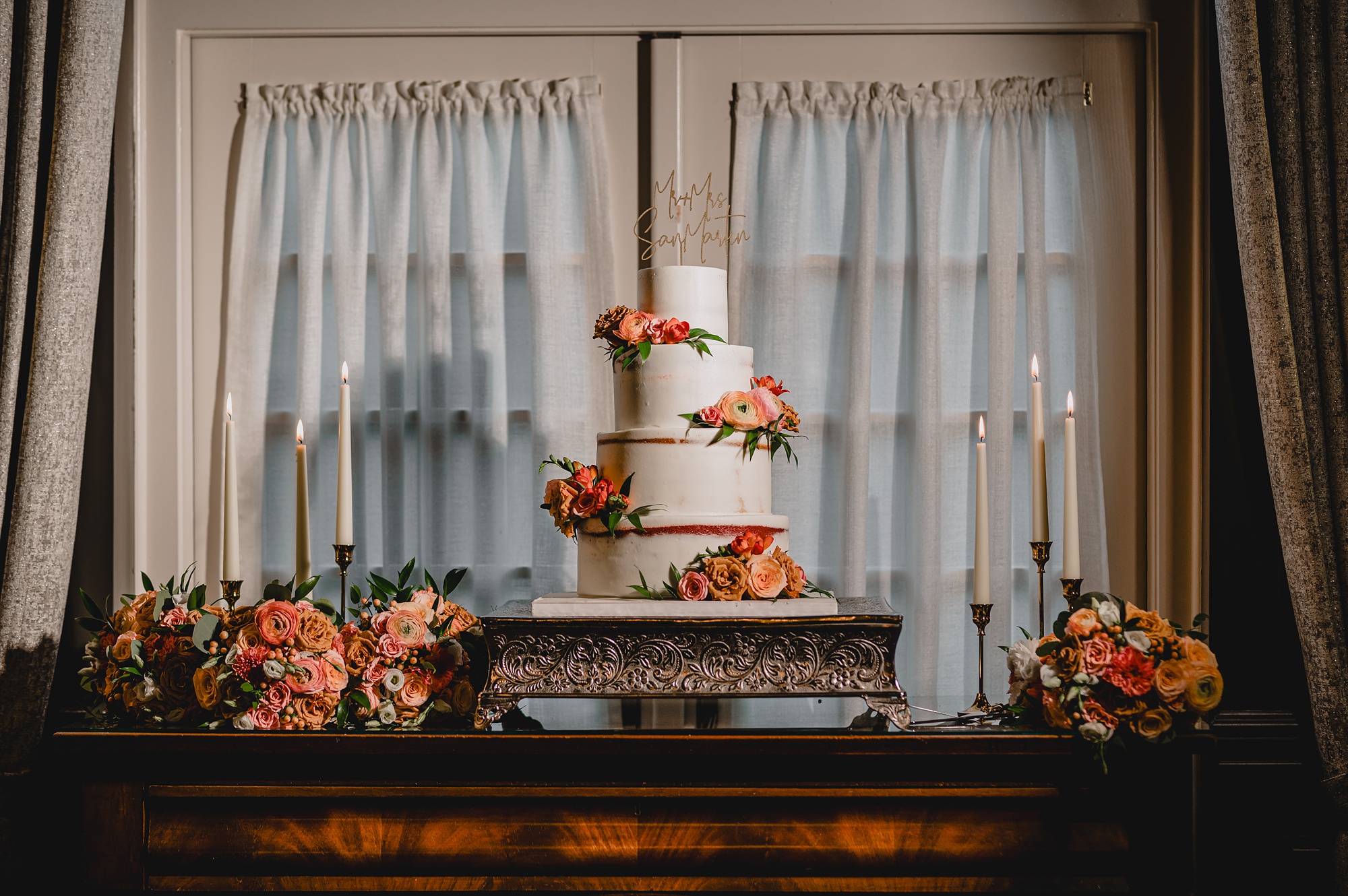 tiered wedding cake with pink flowers on each level