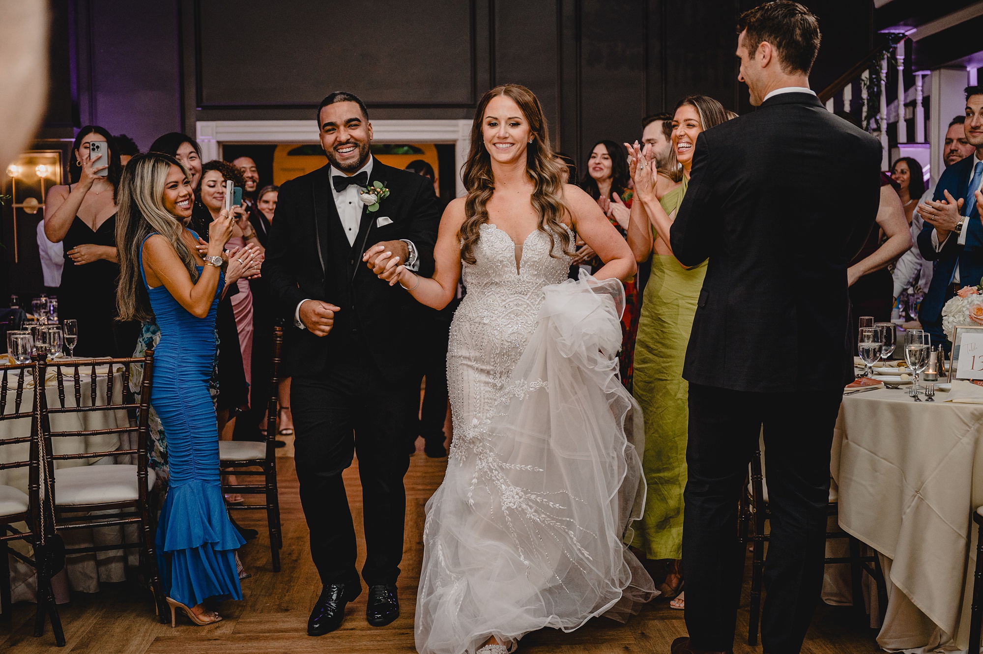 newlyweds hold hands entering reception at David's Country Inn