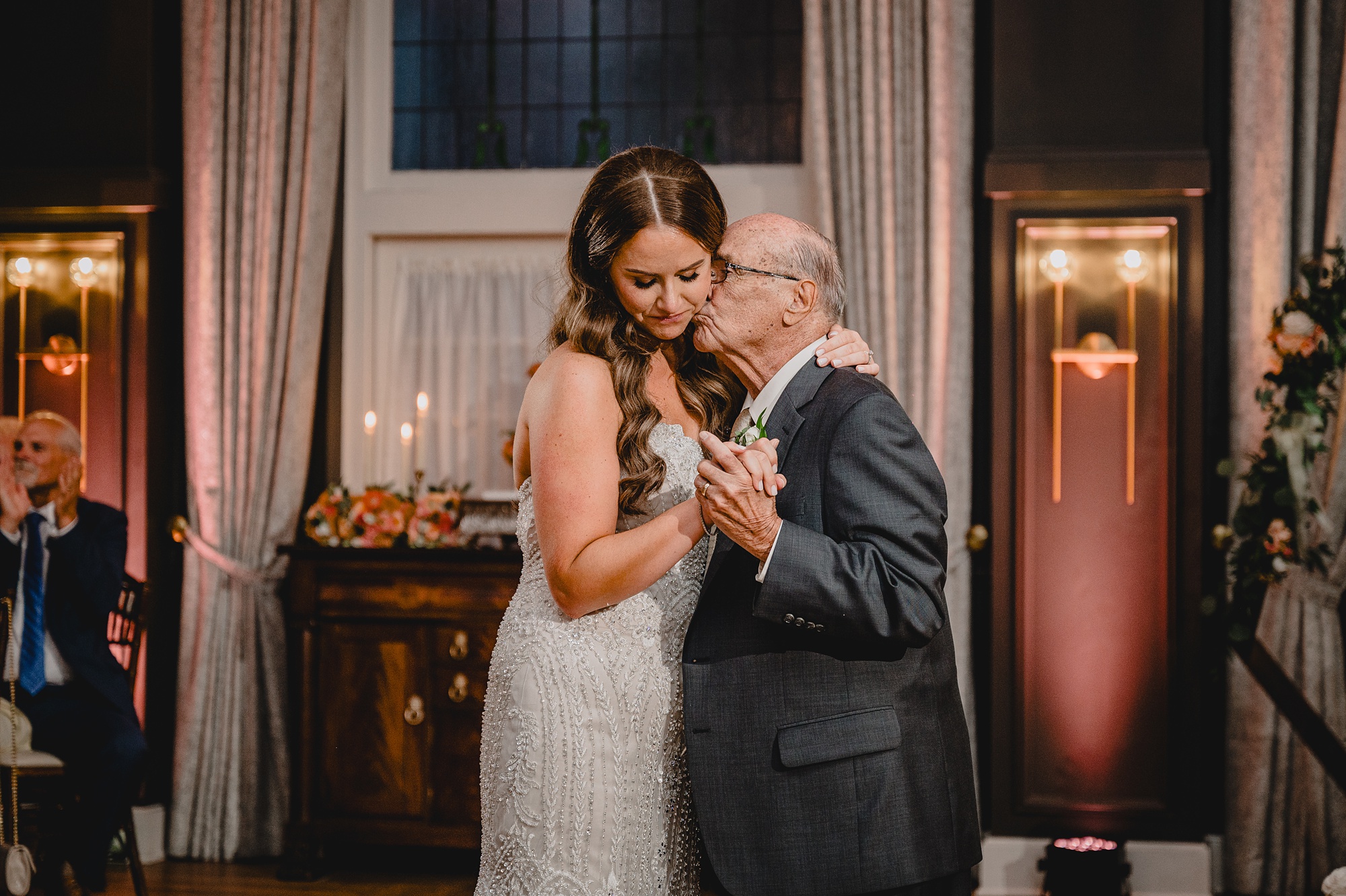 grandfather kisses bride's cheek during NJ wedding reception