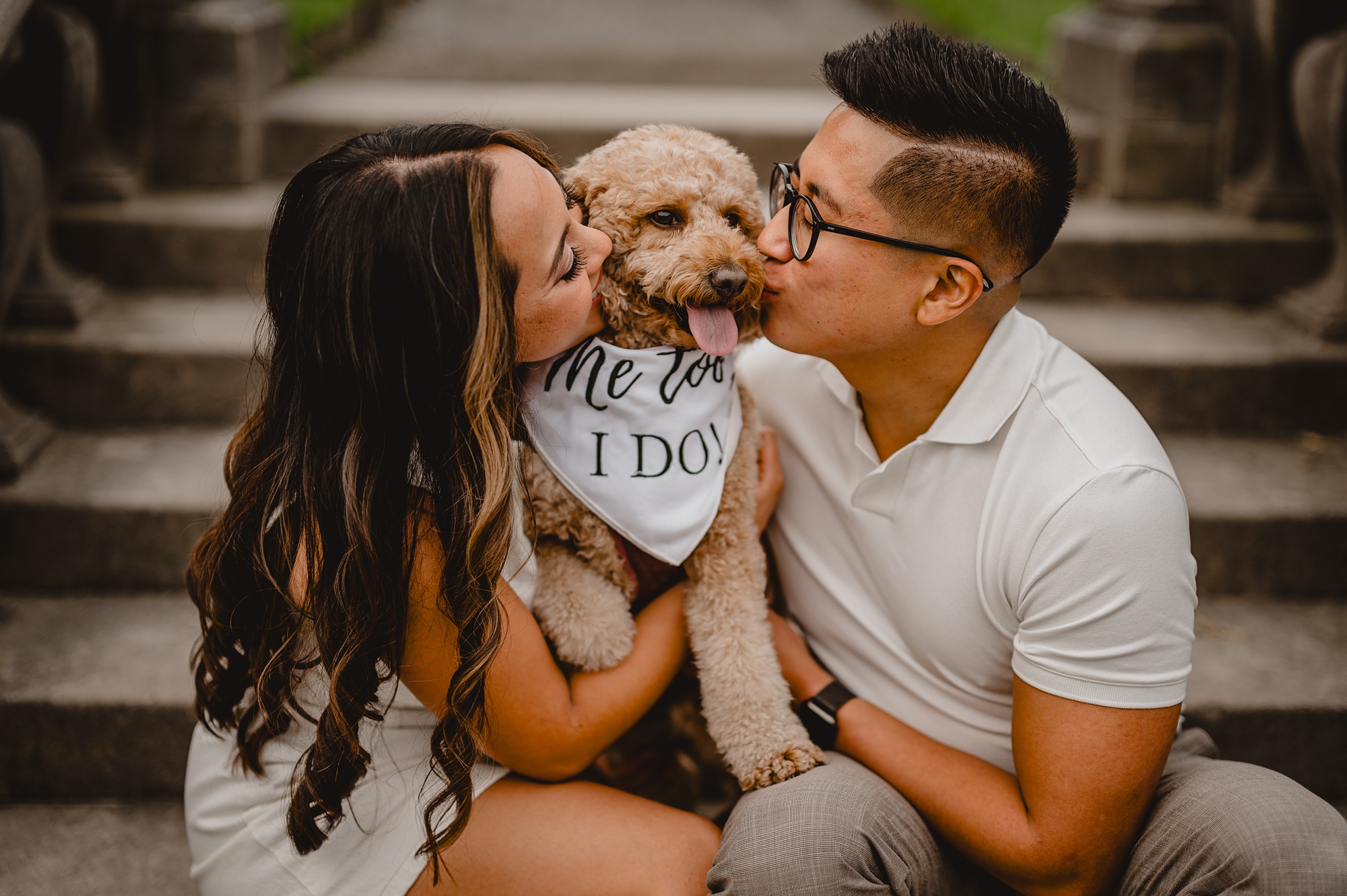 engaged couple kisses puppy dog with "I do" bandanna 