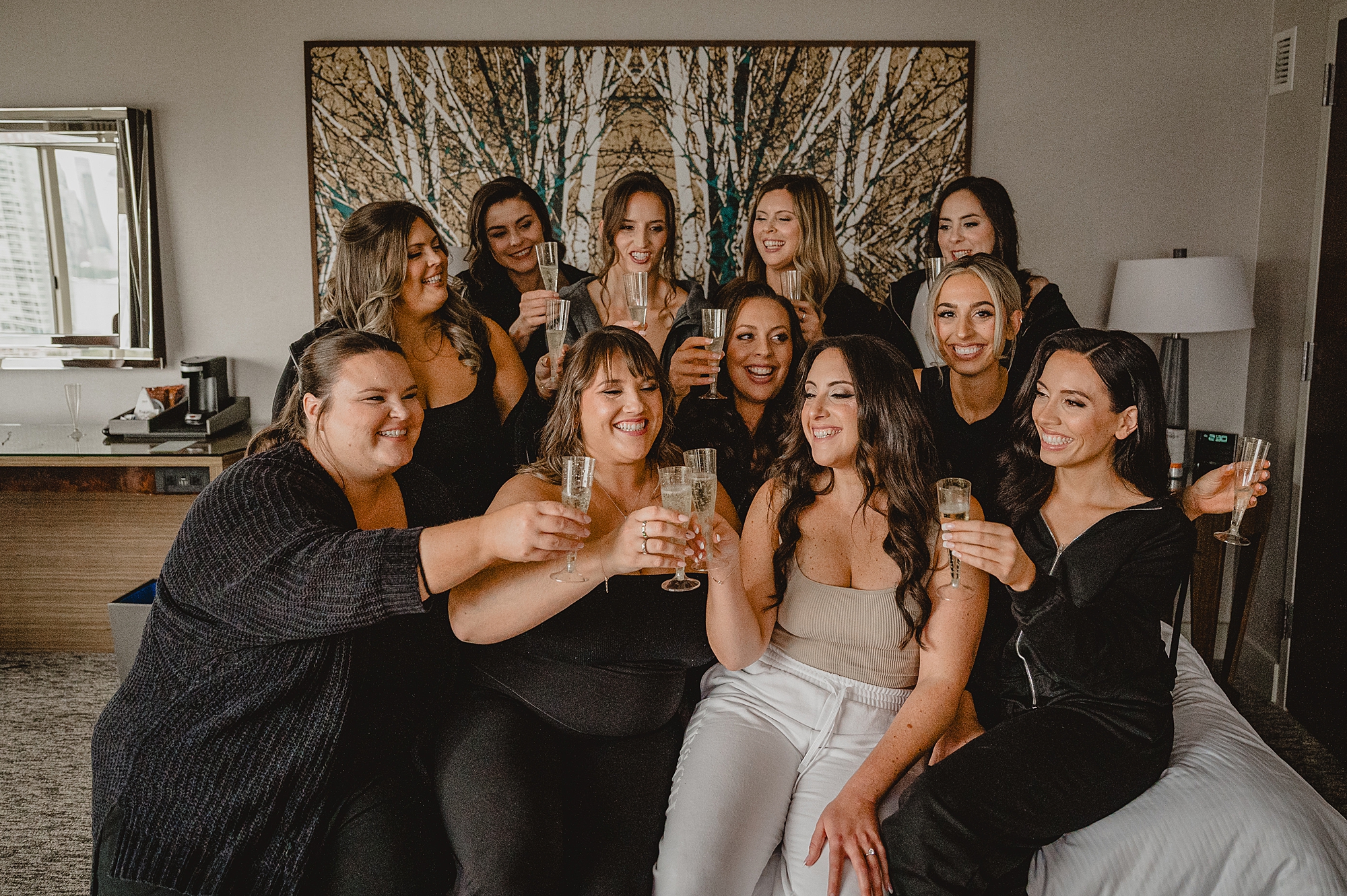 bride and bridesmaids toast champagne in Jersey City hotel