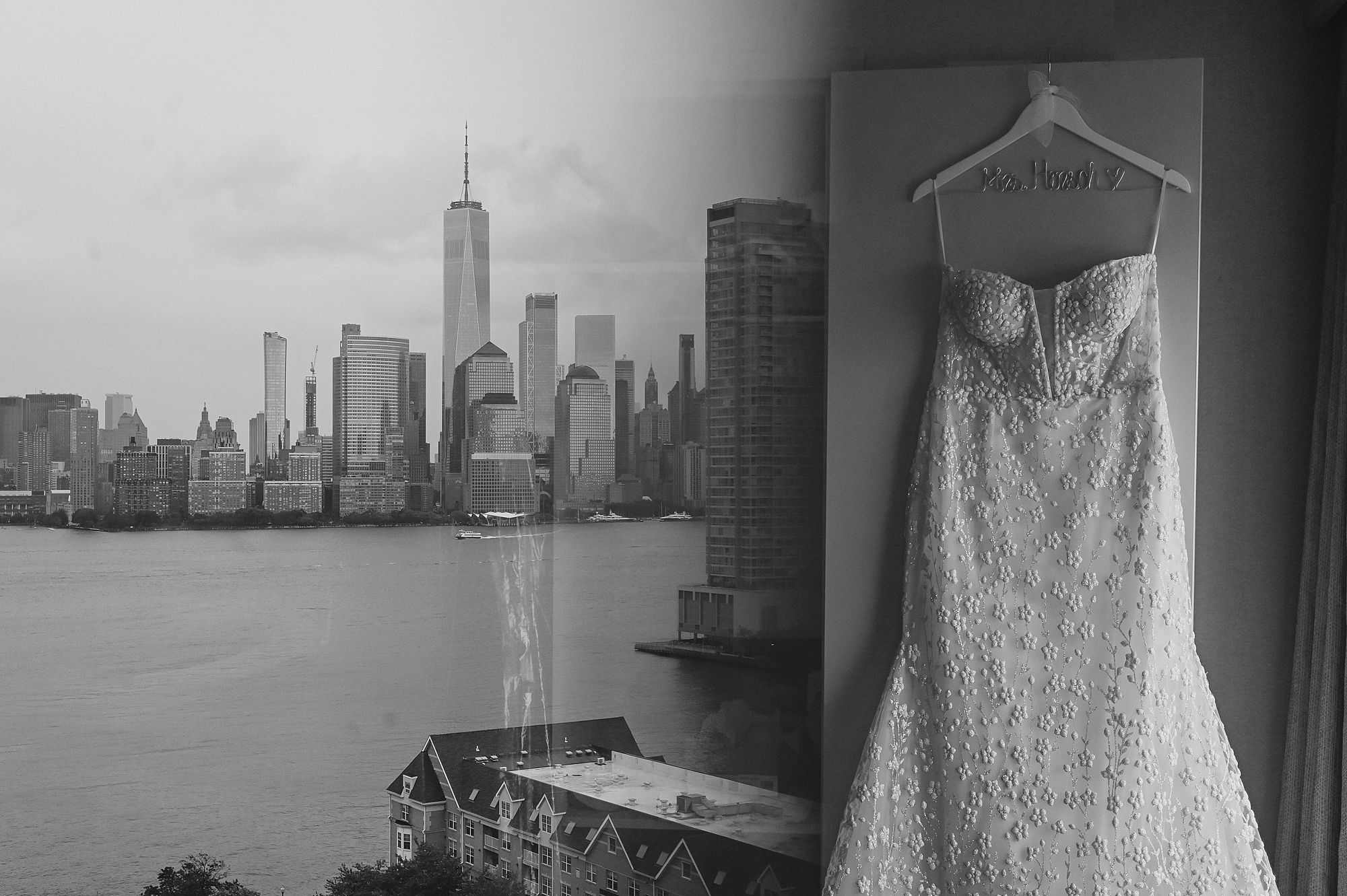 wedding dress hangs on door in Jersey City hotel