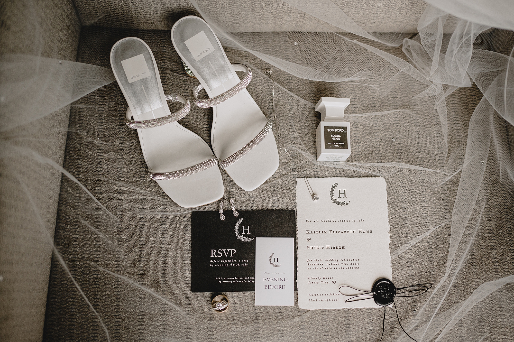 bride's white sandals with perfume and black and white invitation suite for the Liberty House wedding