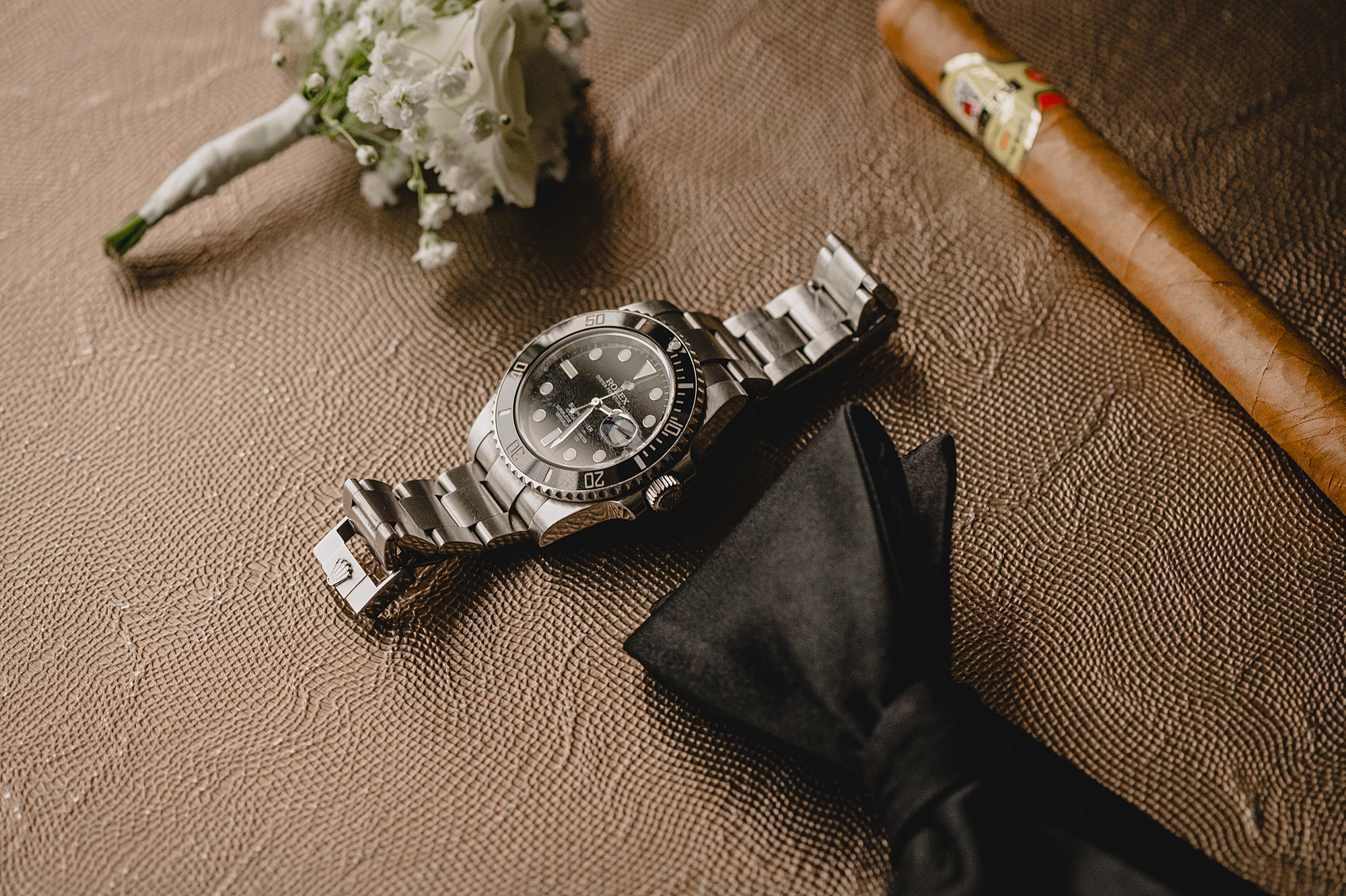 groom's silver watch with black bow tie for wedding day