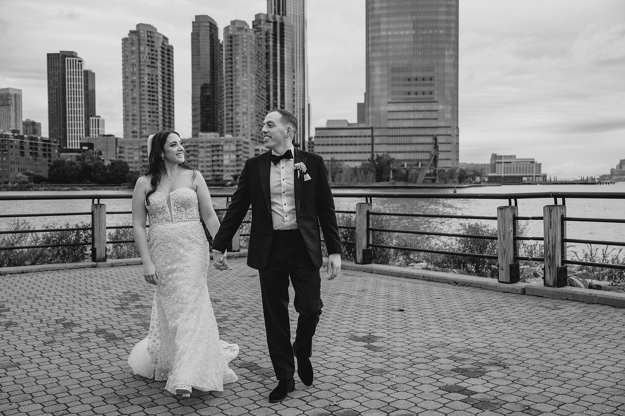 bride and groom hold hands walking on patio of the Liberty House