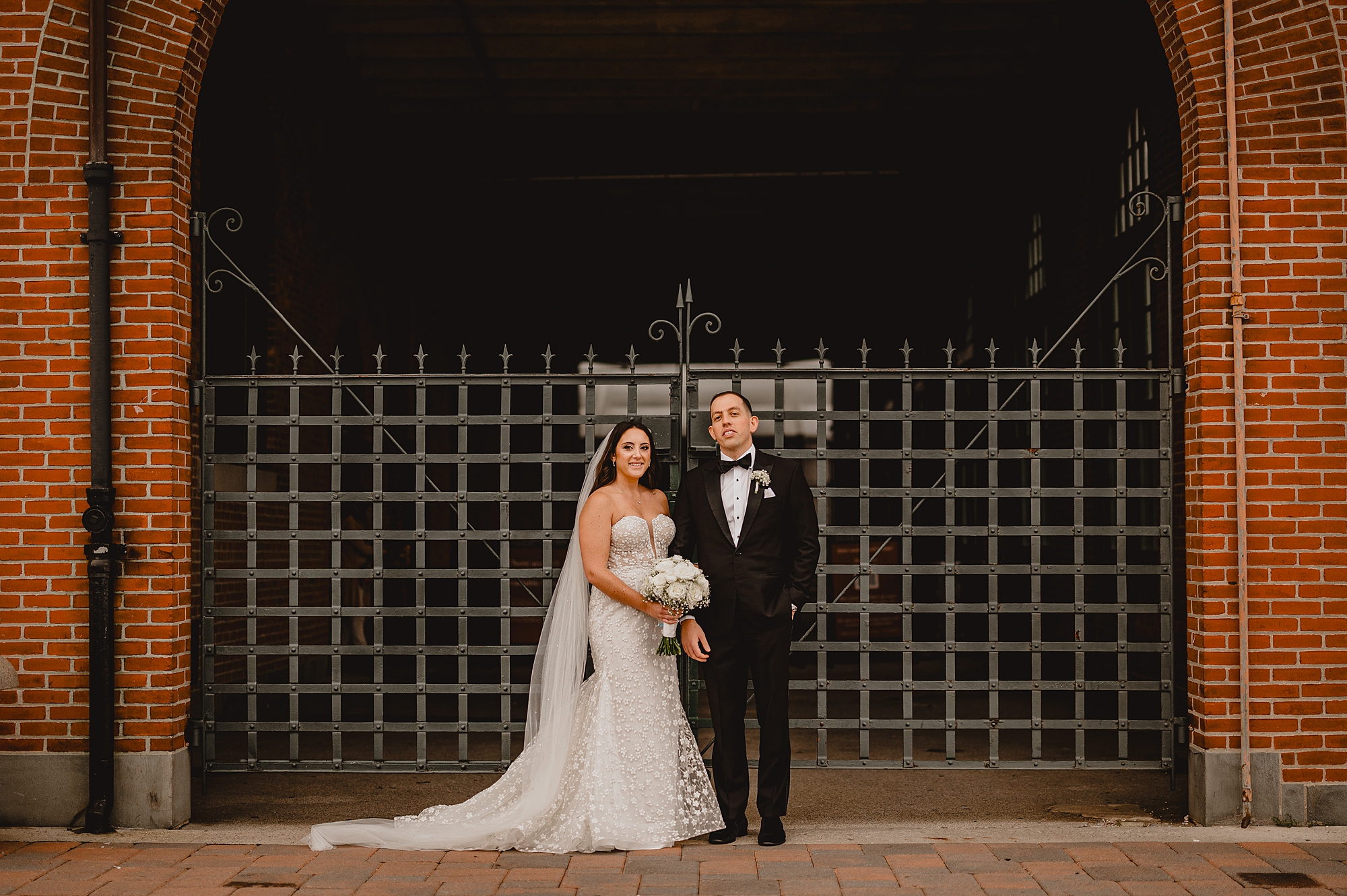 newlyweds hug in front of the Liberty House