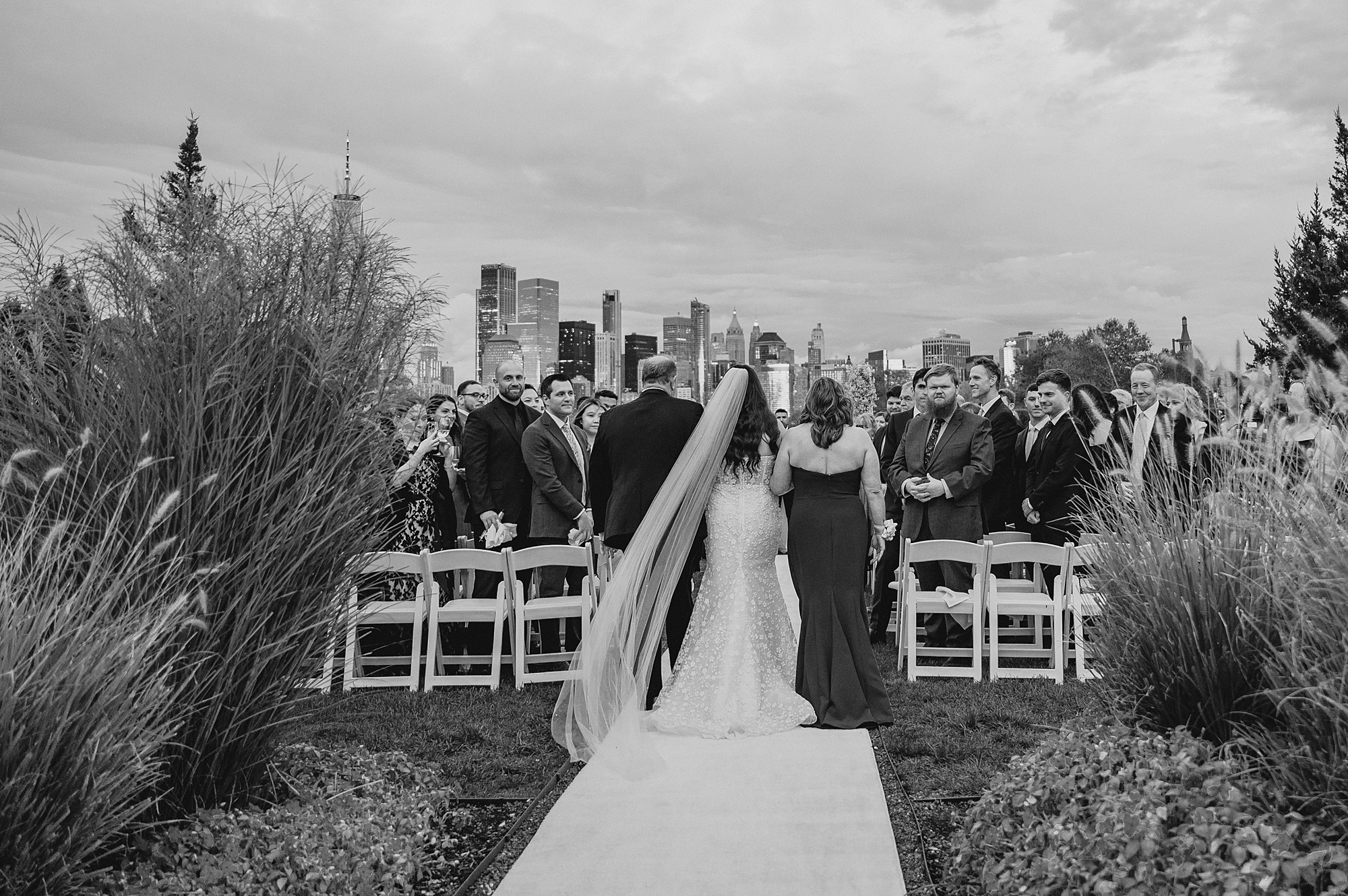 bride is escorted down aisle by mother and father