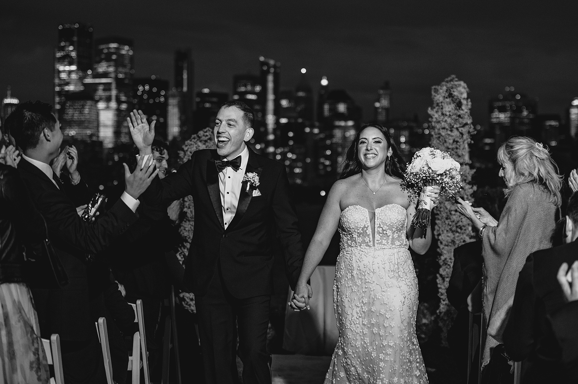 bride and groom cheer walking up aisle at the Liberty House