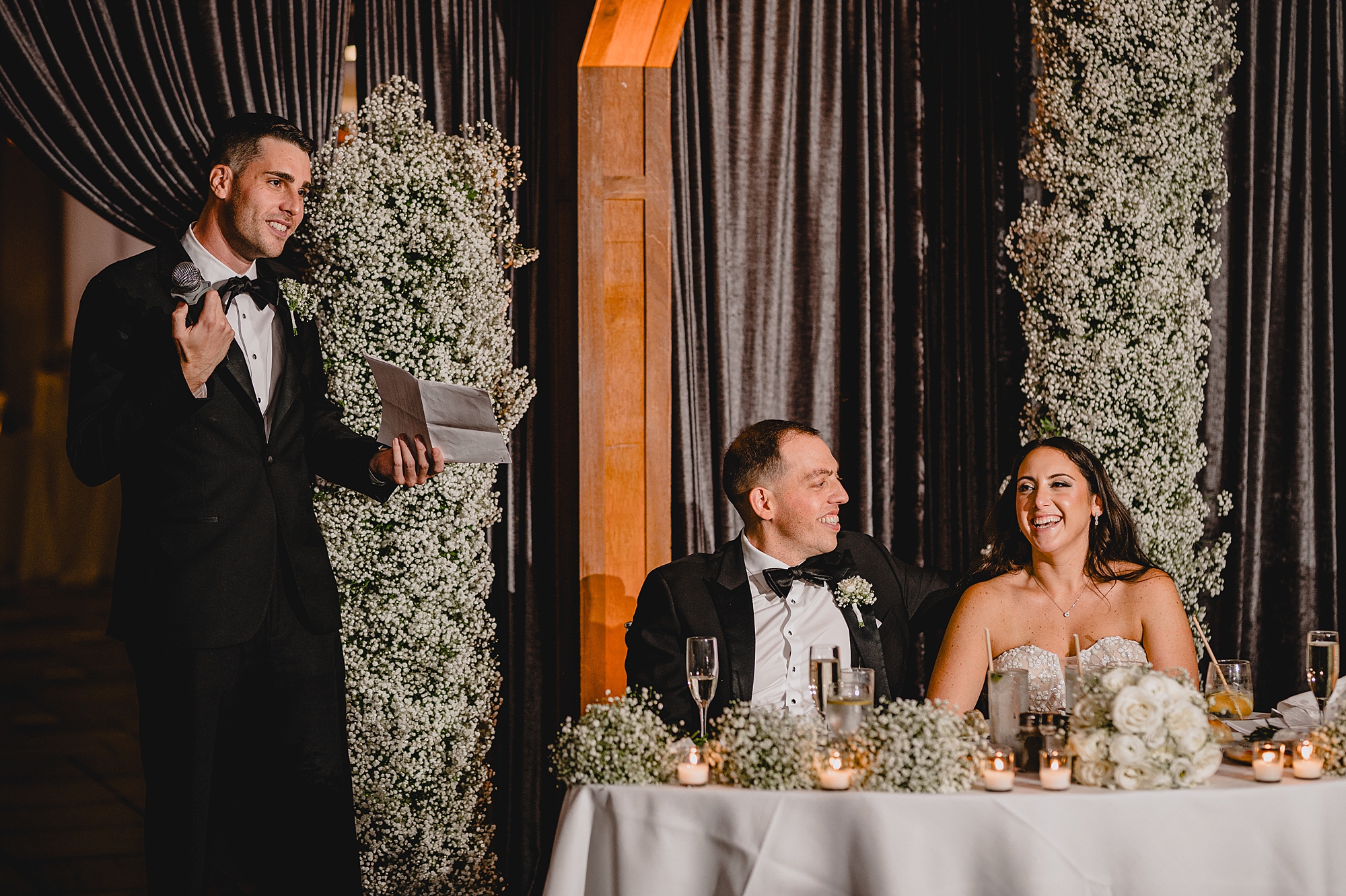 bride and groom listen to toasts during Jersey City reception