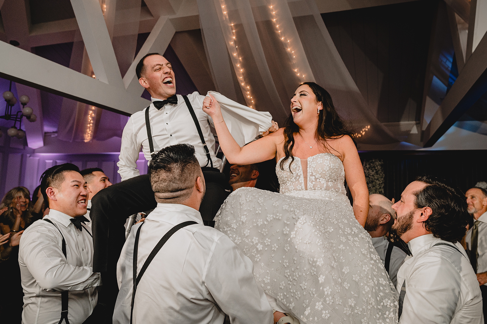 wedding guests lift up bride and groom during hora at the Liberty House