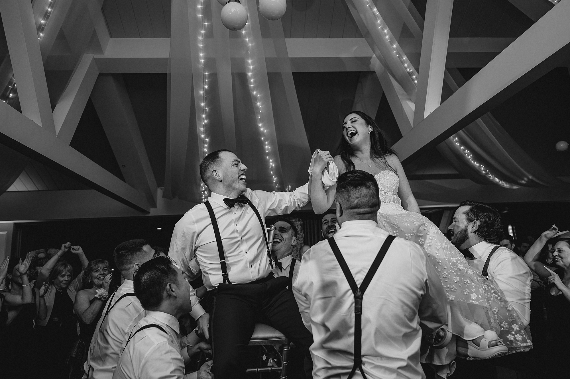 wedding guests lift up bride and groom during hora at the Liberty House