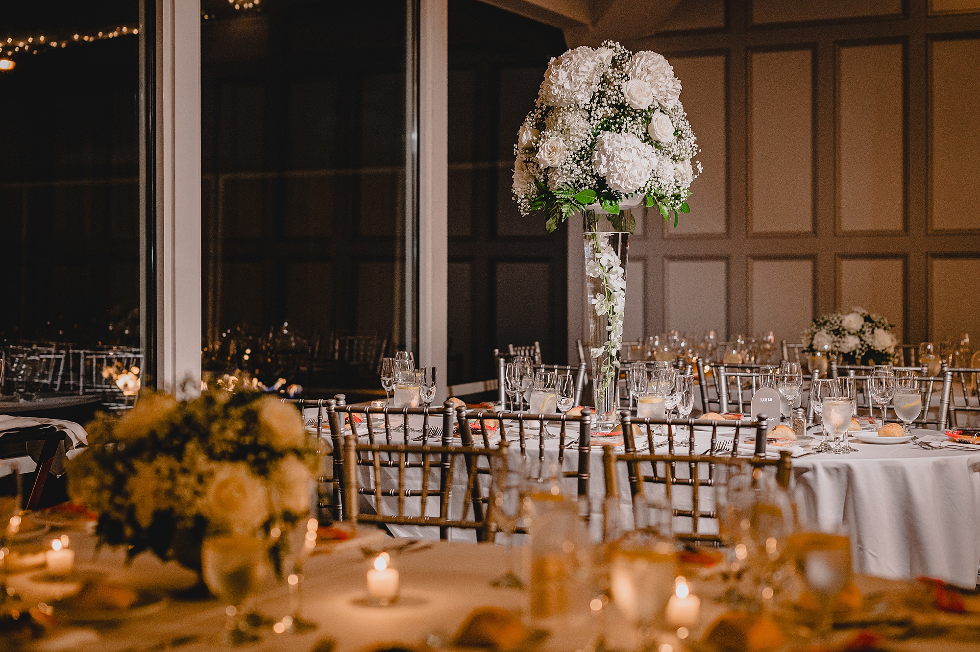 wedding reception with tall floral centerpieces at the Liberty House