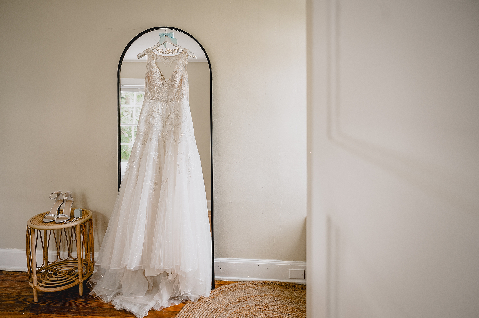 wedding dress hangs on mirror in Hudson NY bridal suite