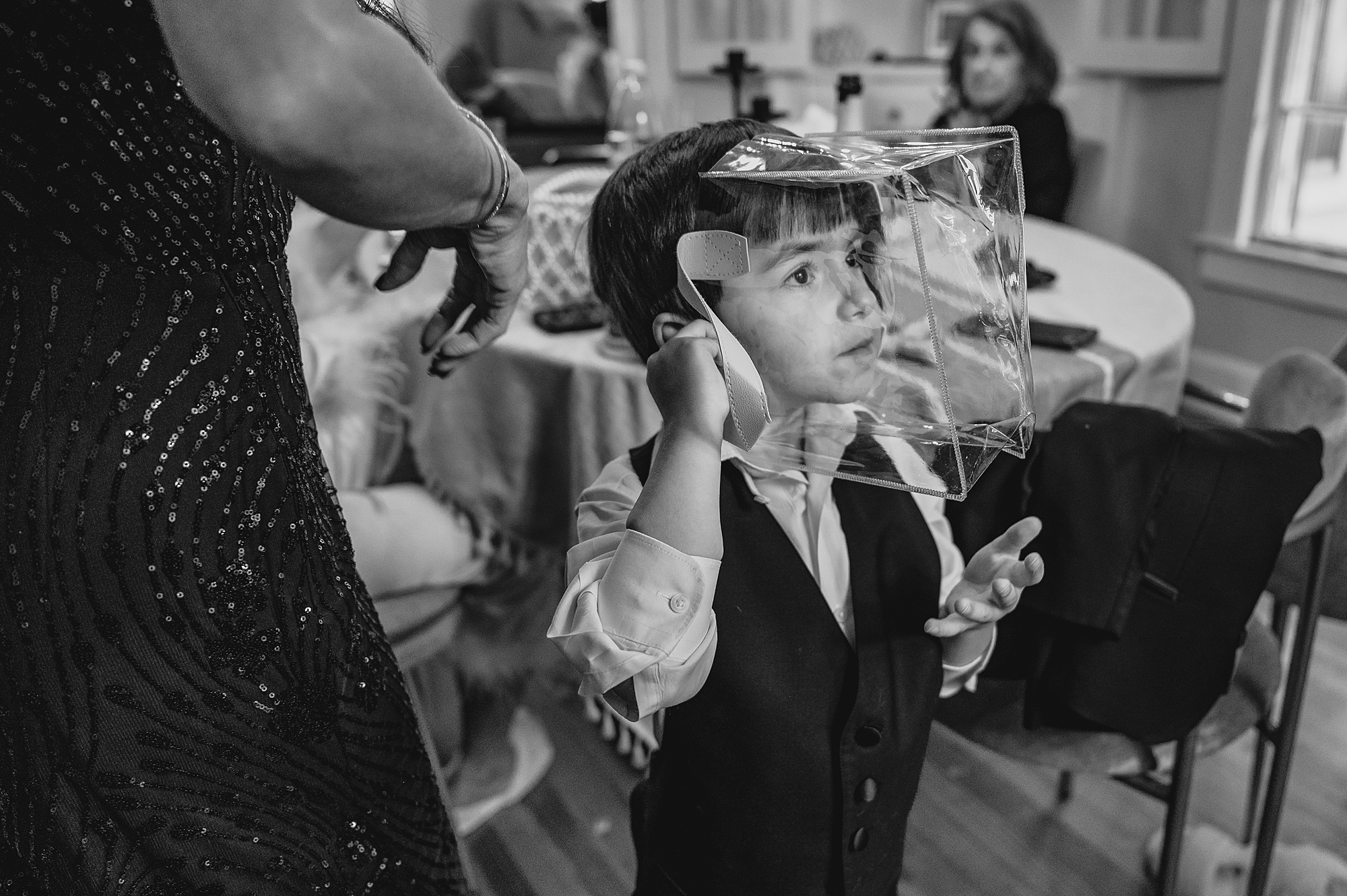 boy plays with decorations during prep for NY wedding