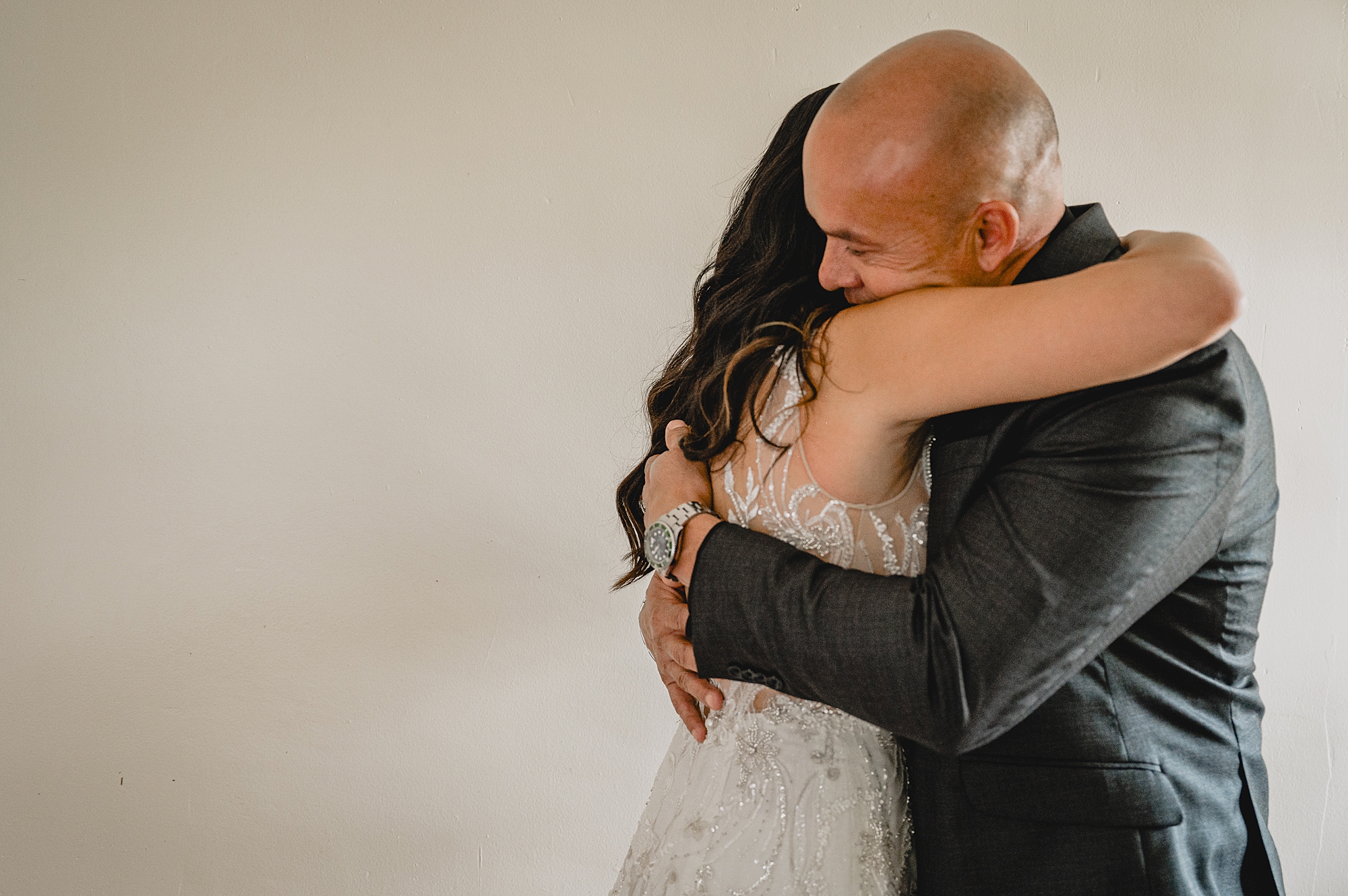 bride hugs dad during first look at wedding at the Garrison