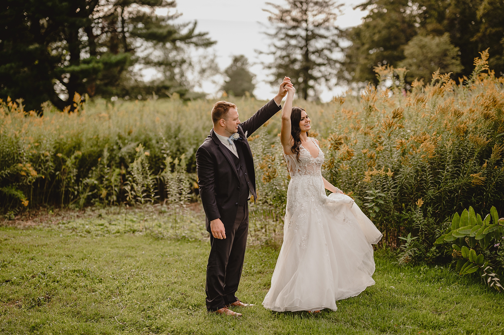 groom twirls bride during photos at the Garrison