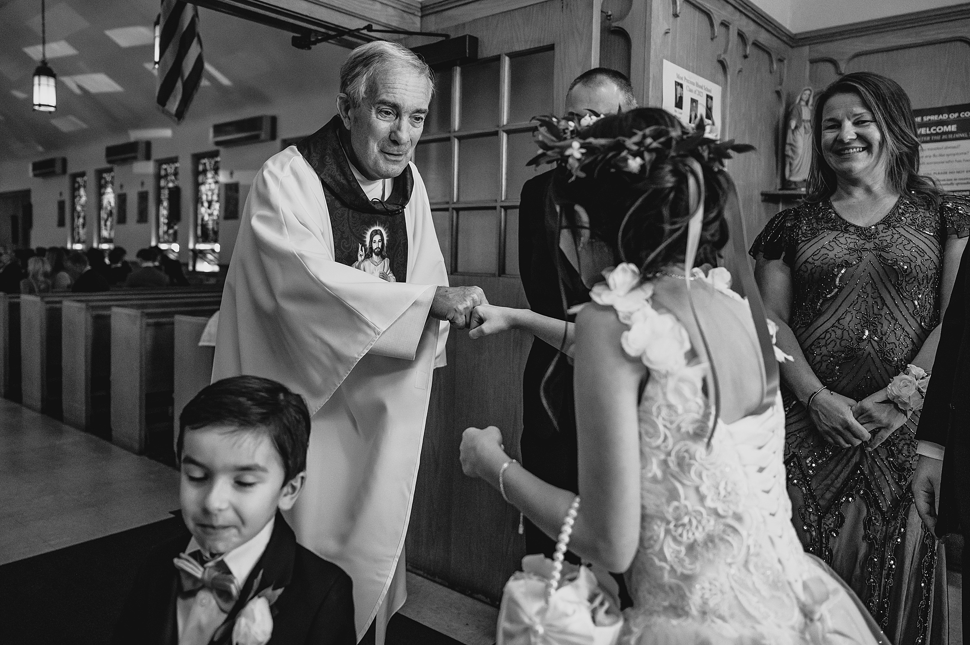 priest reaches to greet guests in New York church
