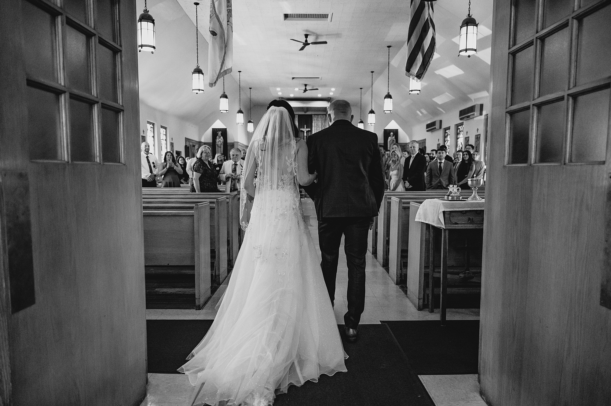 father escorts bride down aisle for traditional church ceremony