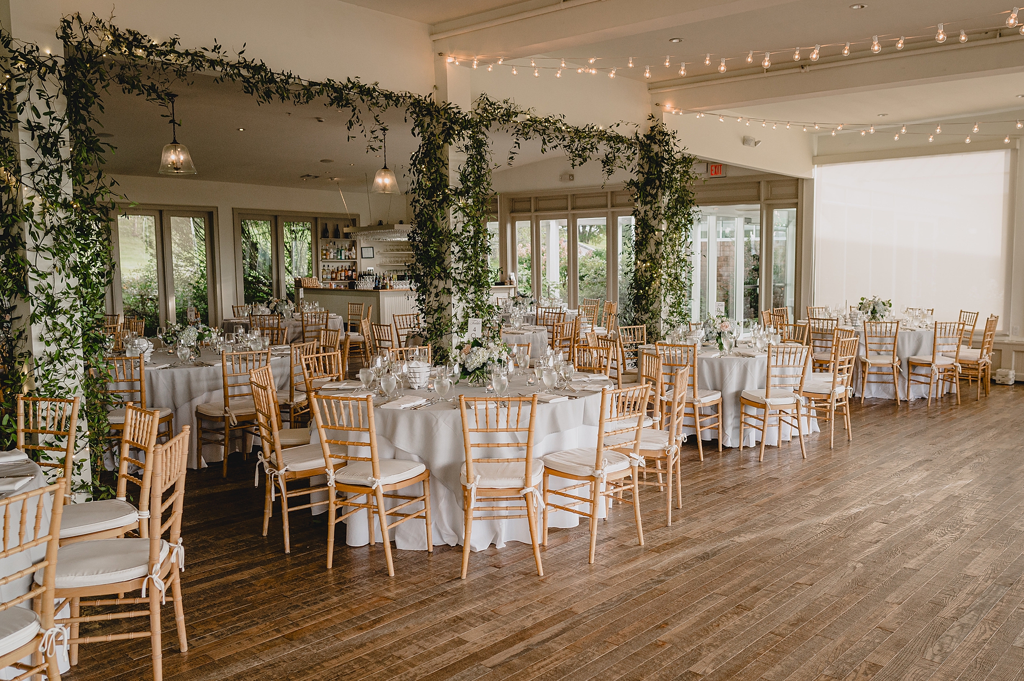 wedding reception with greenery hanging on walls at the Garrison in Hudson NY