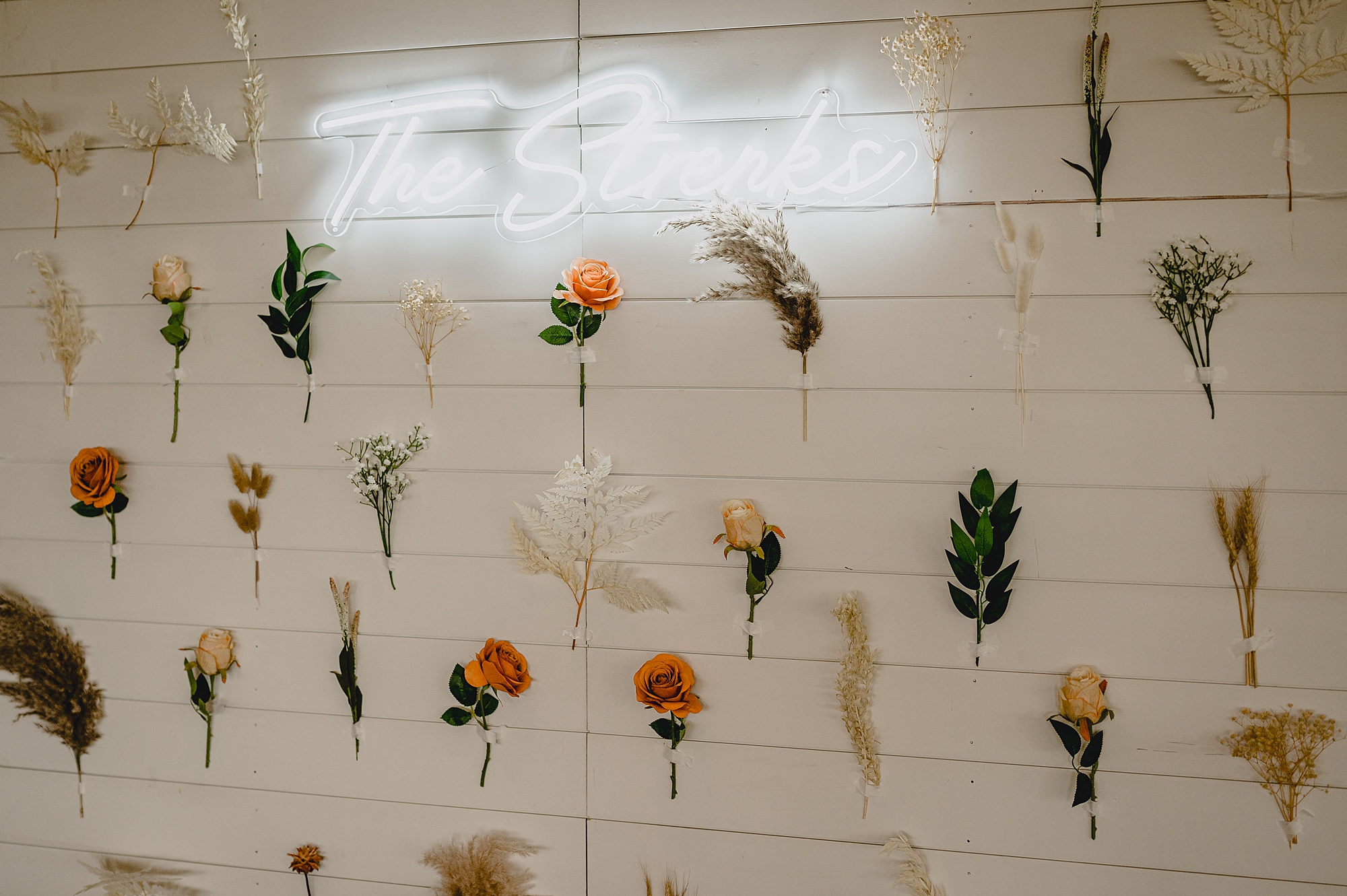 custom neon sign with hanging floral wall for photos