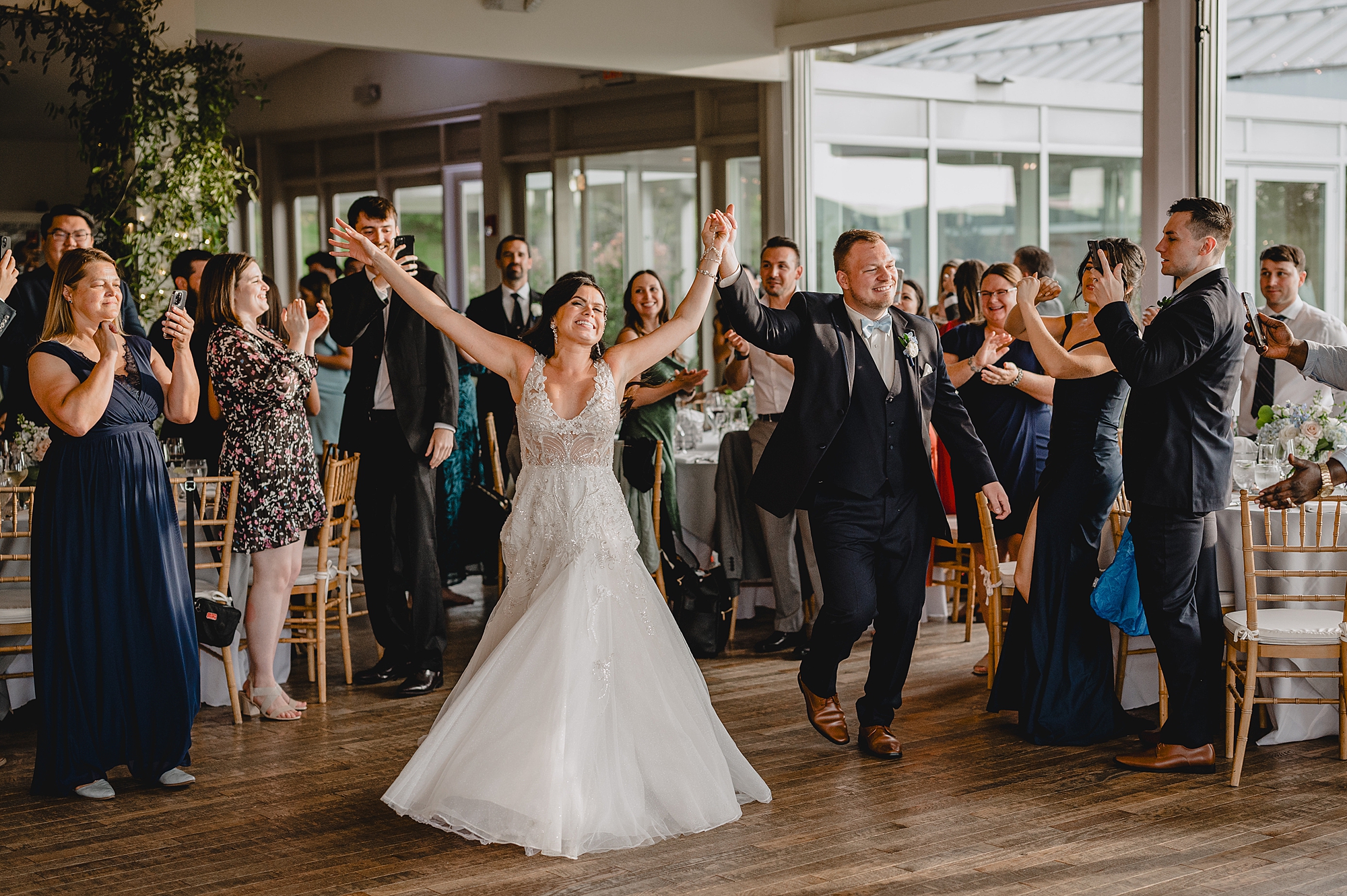 bride and groom cheer entering wedding reception at the Garrison