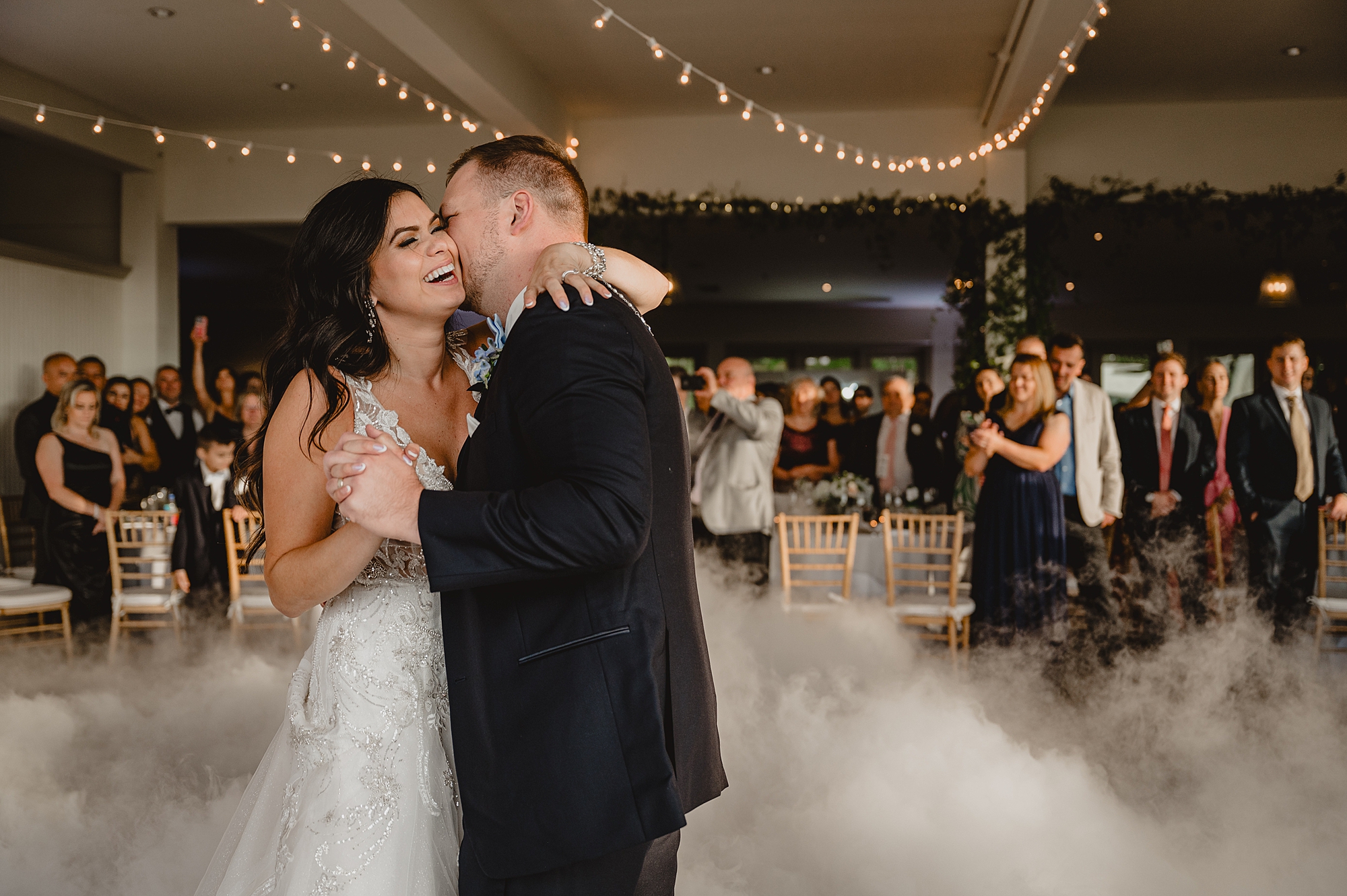 bride and groom dance in fog at wedding reception at the Garrison