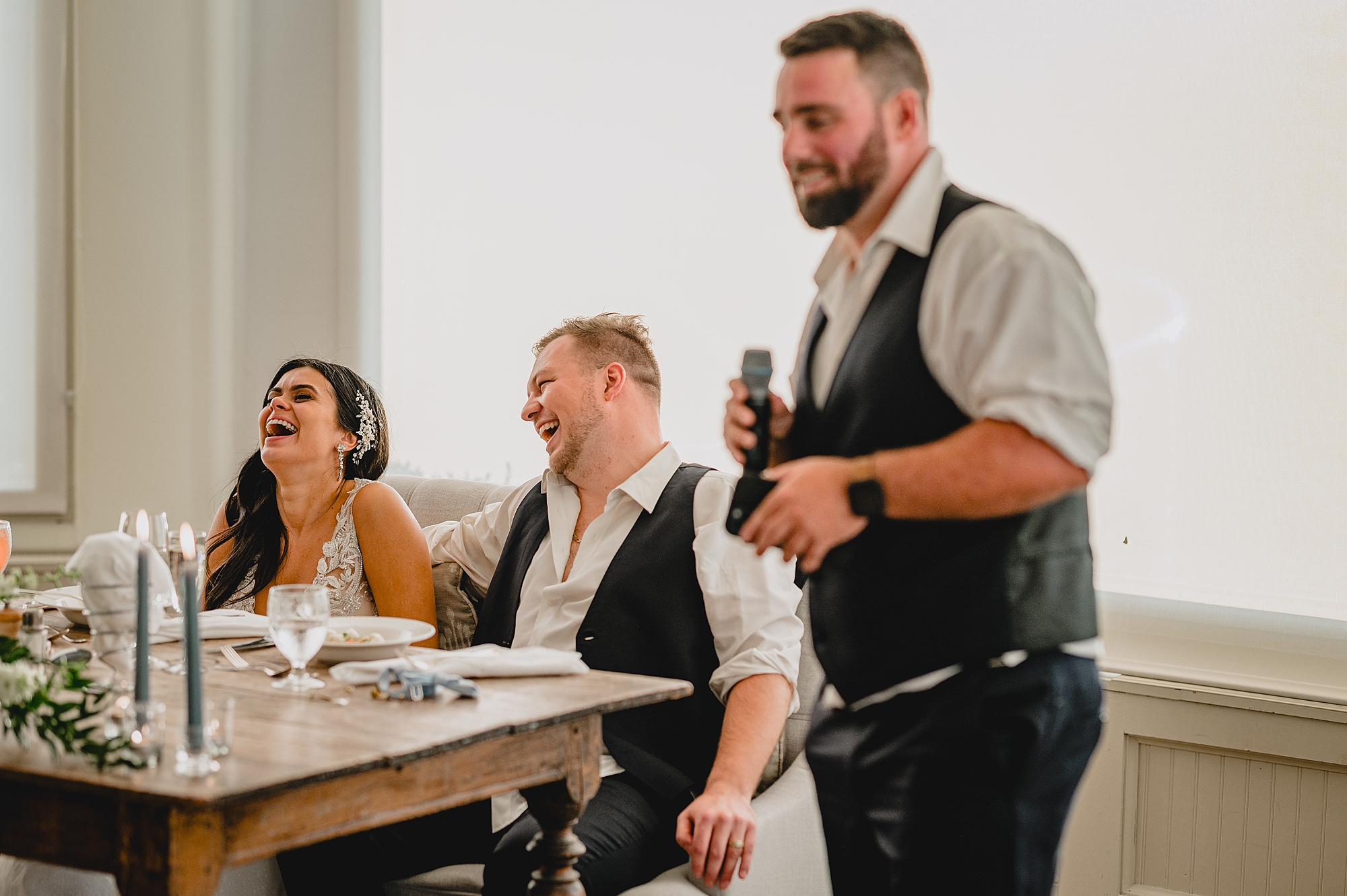 newlyweds listen to toasts during wedding reception at the Garrison