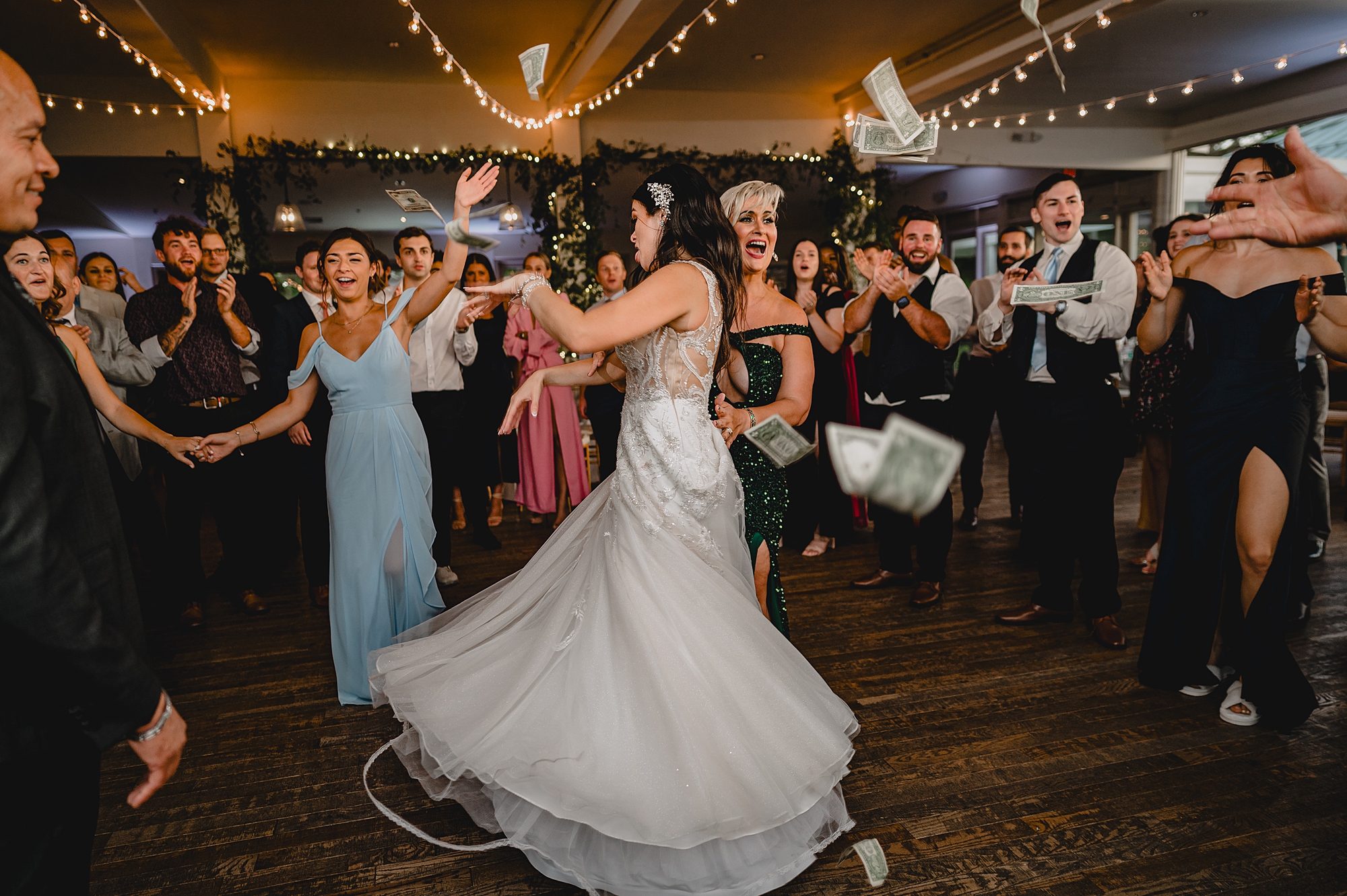 bride twirls around on dance floor with guests