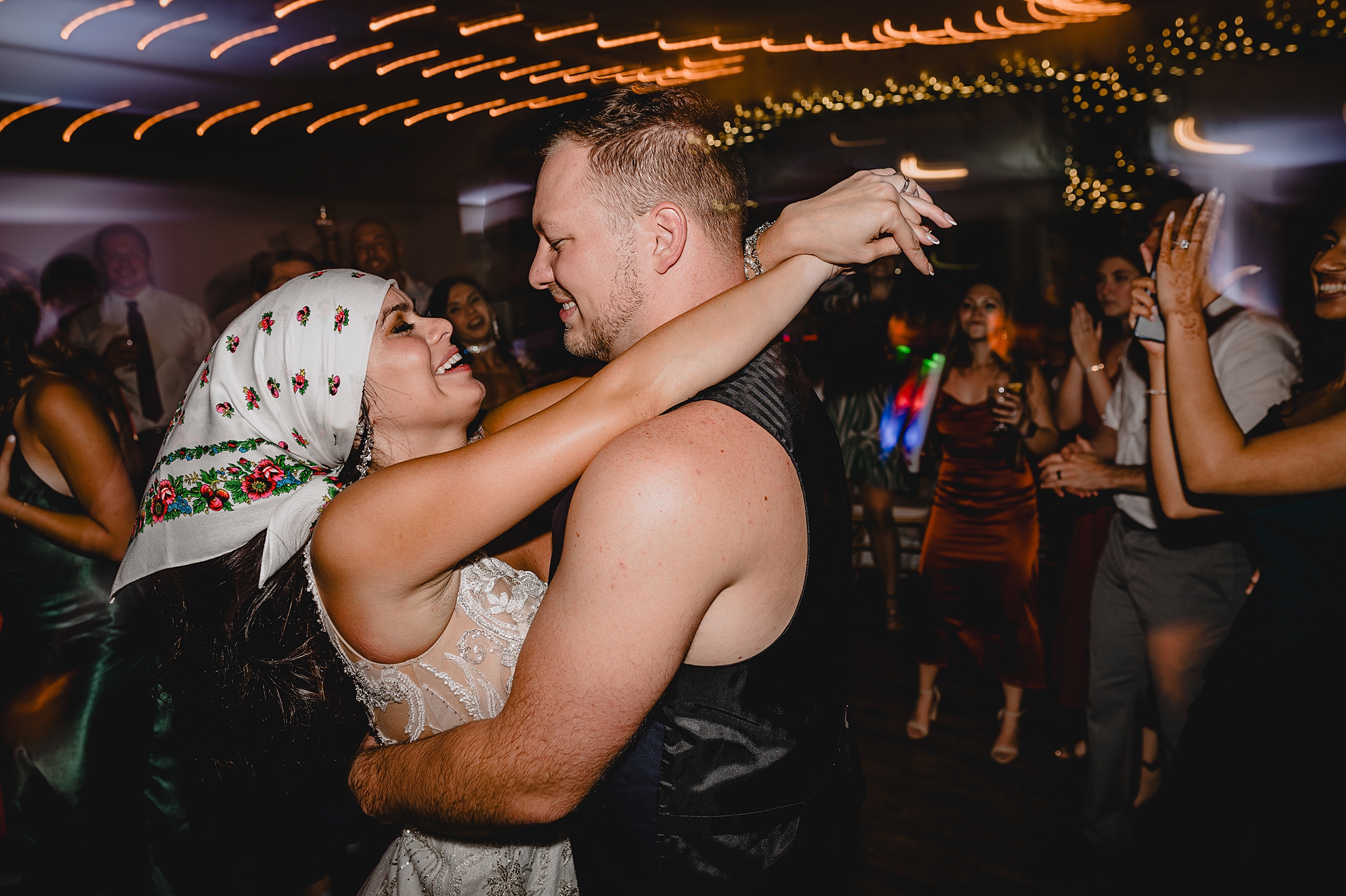 bride and groom dance during wedding reception in biker's gear