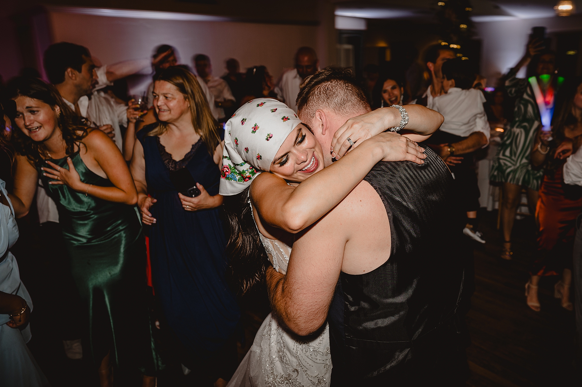 bride and groom dance during wedding reception in biker's gear