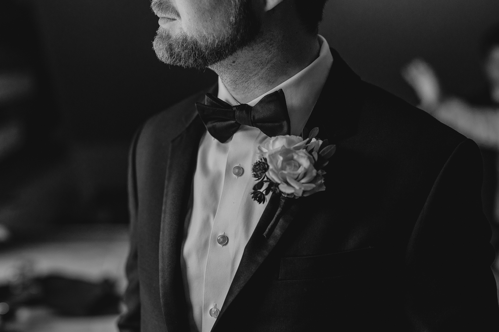 groom shows off small boutonnière on black tux for NJ wedding
