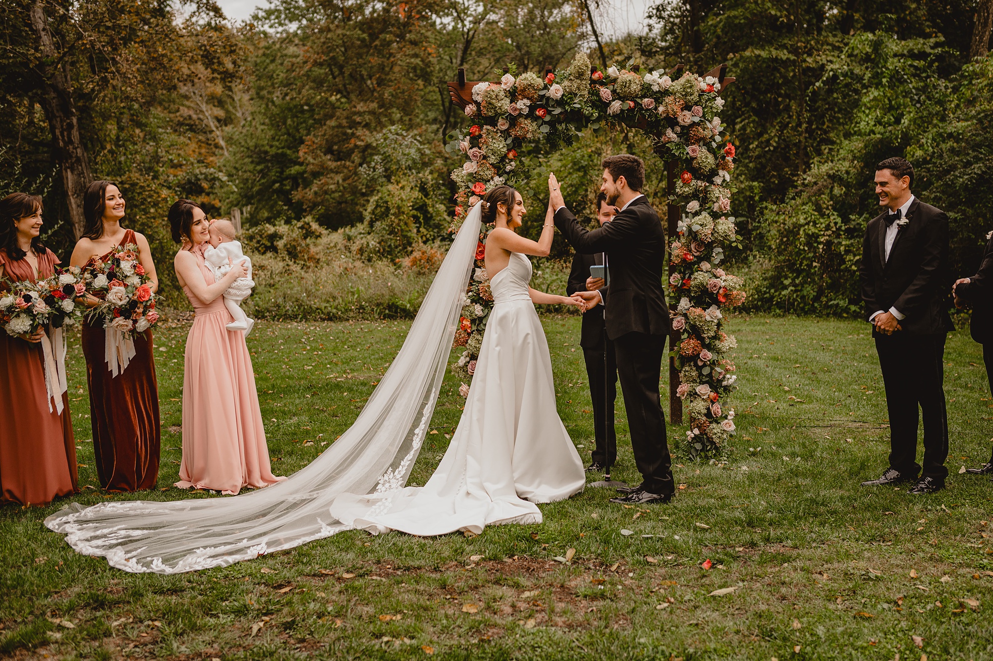 bride and groom high five during wedding ceremony at Waterloo Village