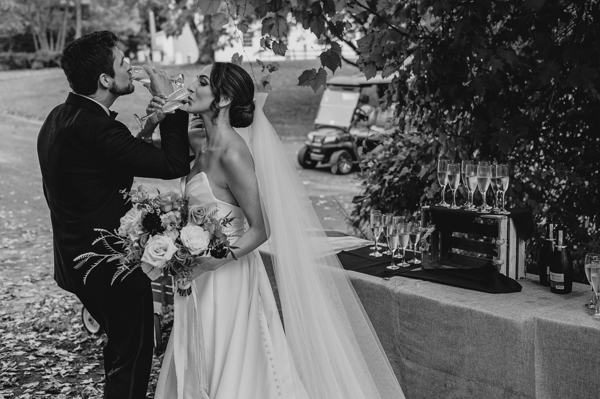 bride and groom link arms to drink champagne 