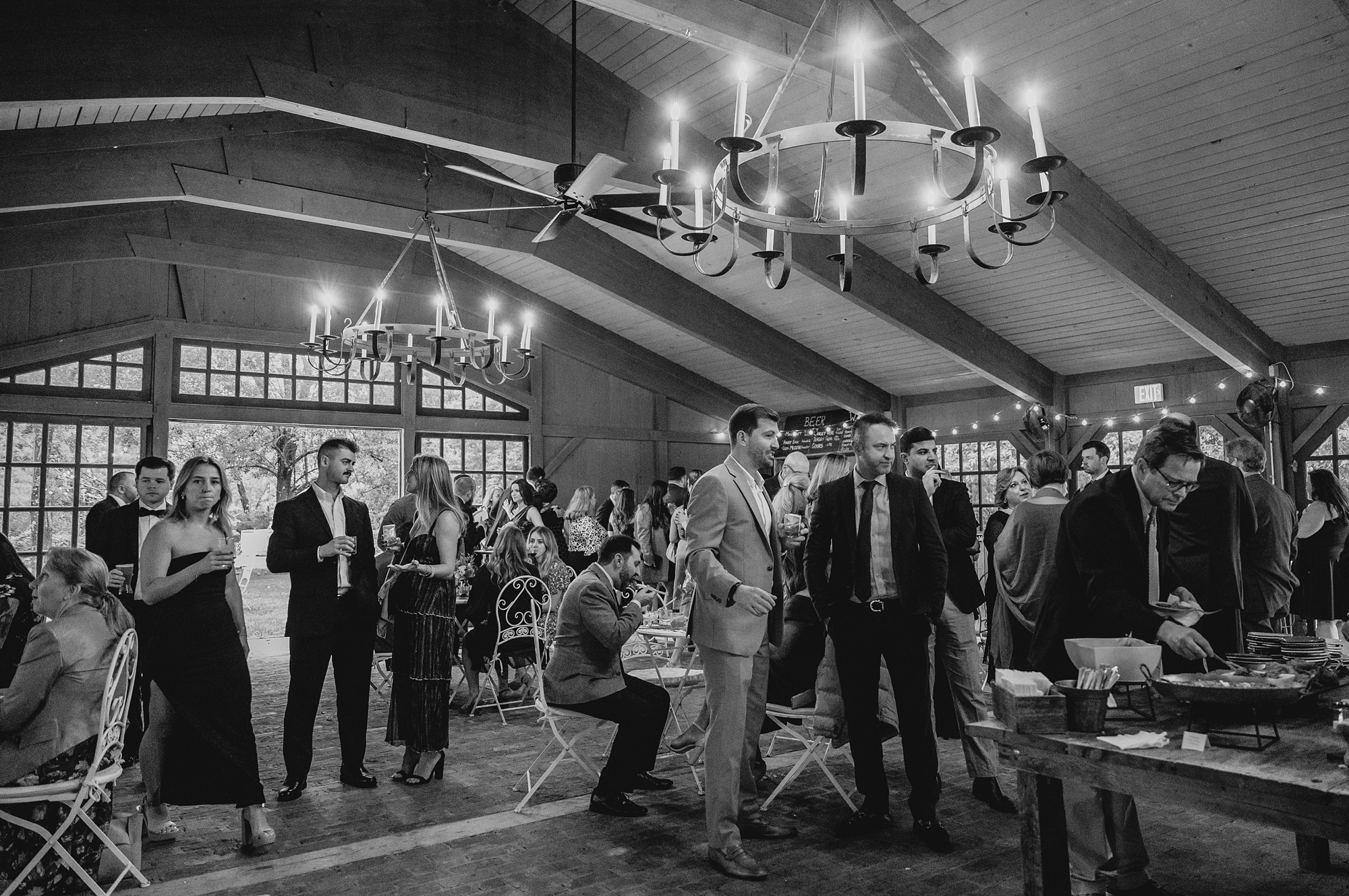 guests mingle inside barn at Waterloo Village
