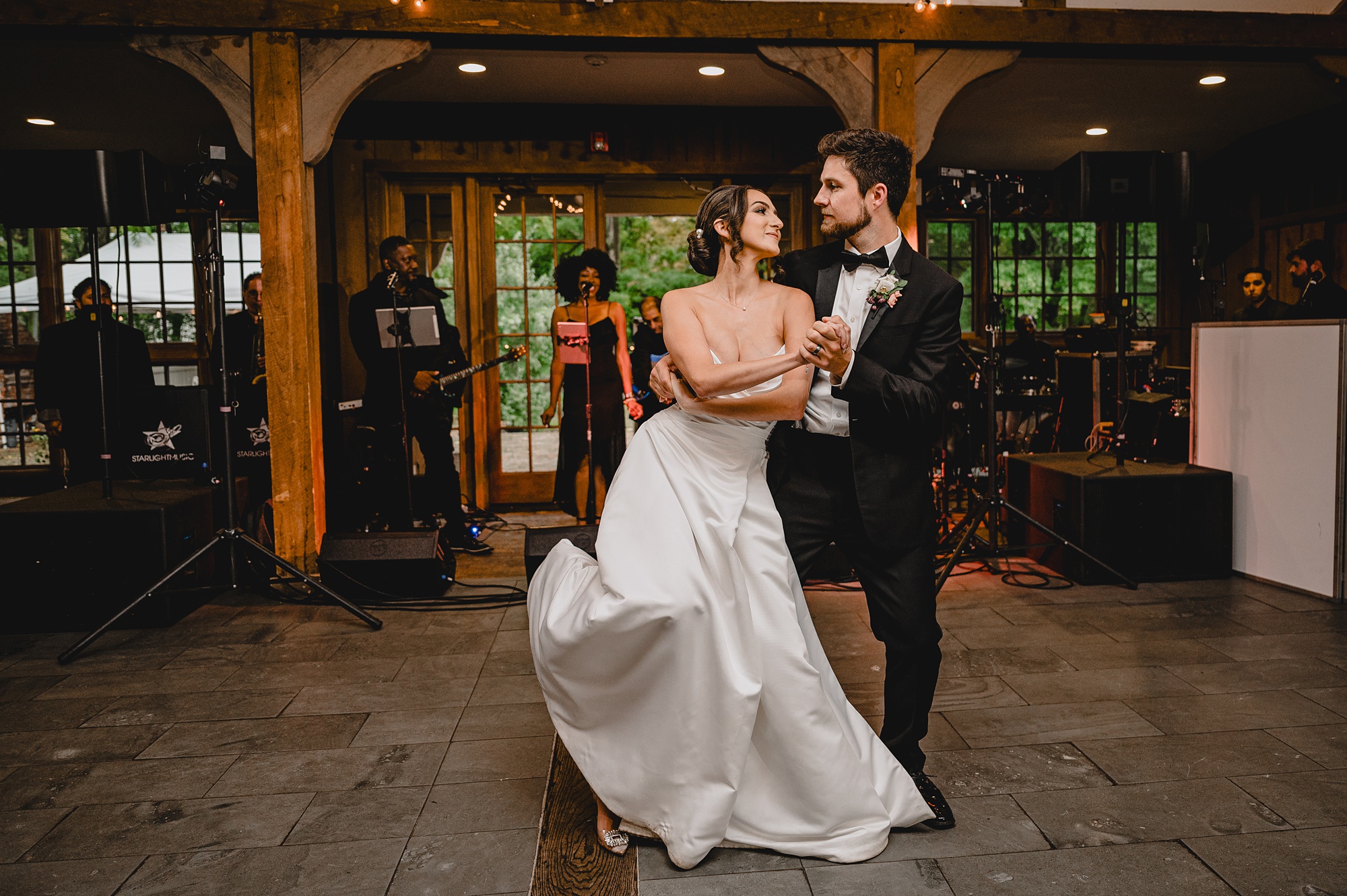 groom twirls bride into him during NJ wedding reception