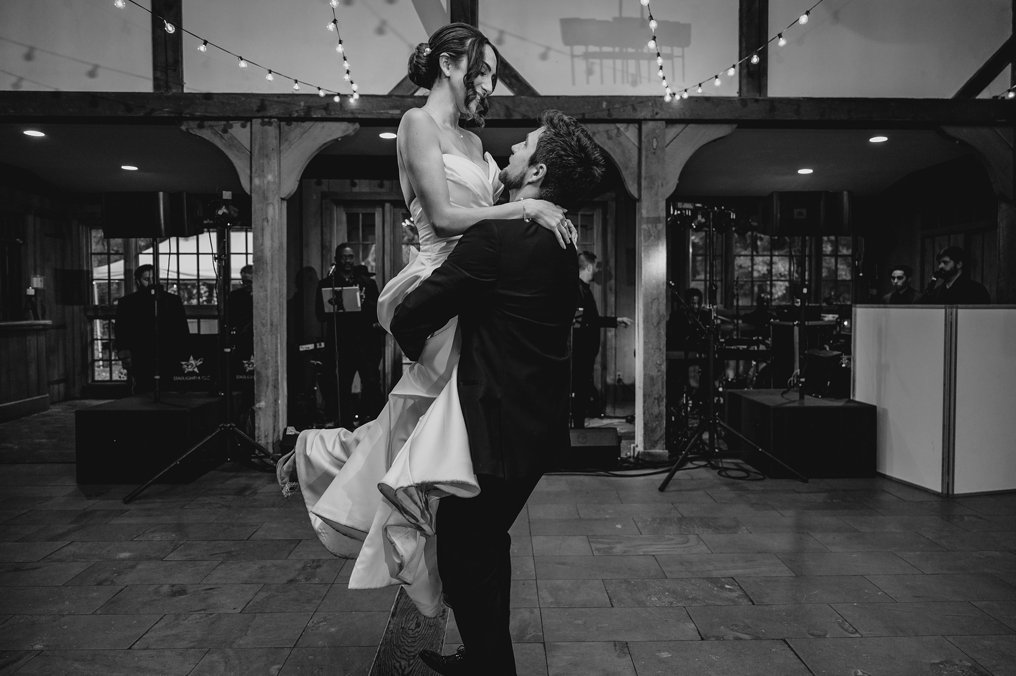 groom lifts up bride during first dance at Waterloo Village