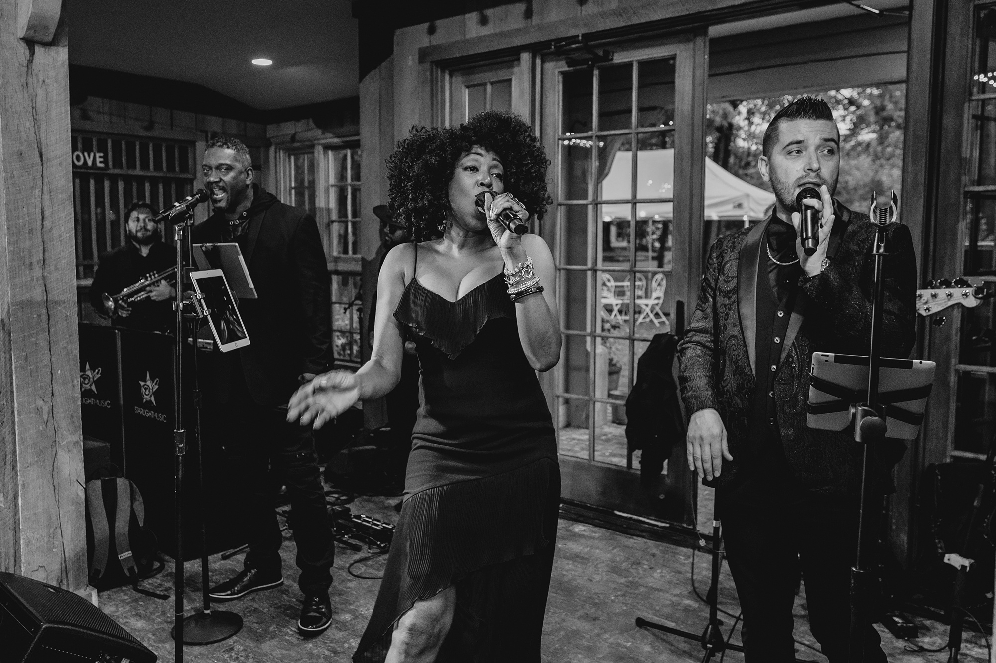 black woman sings during wedding reception 