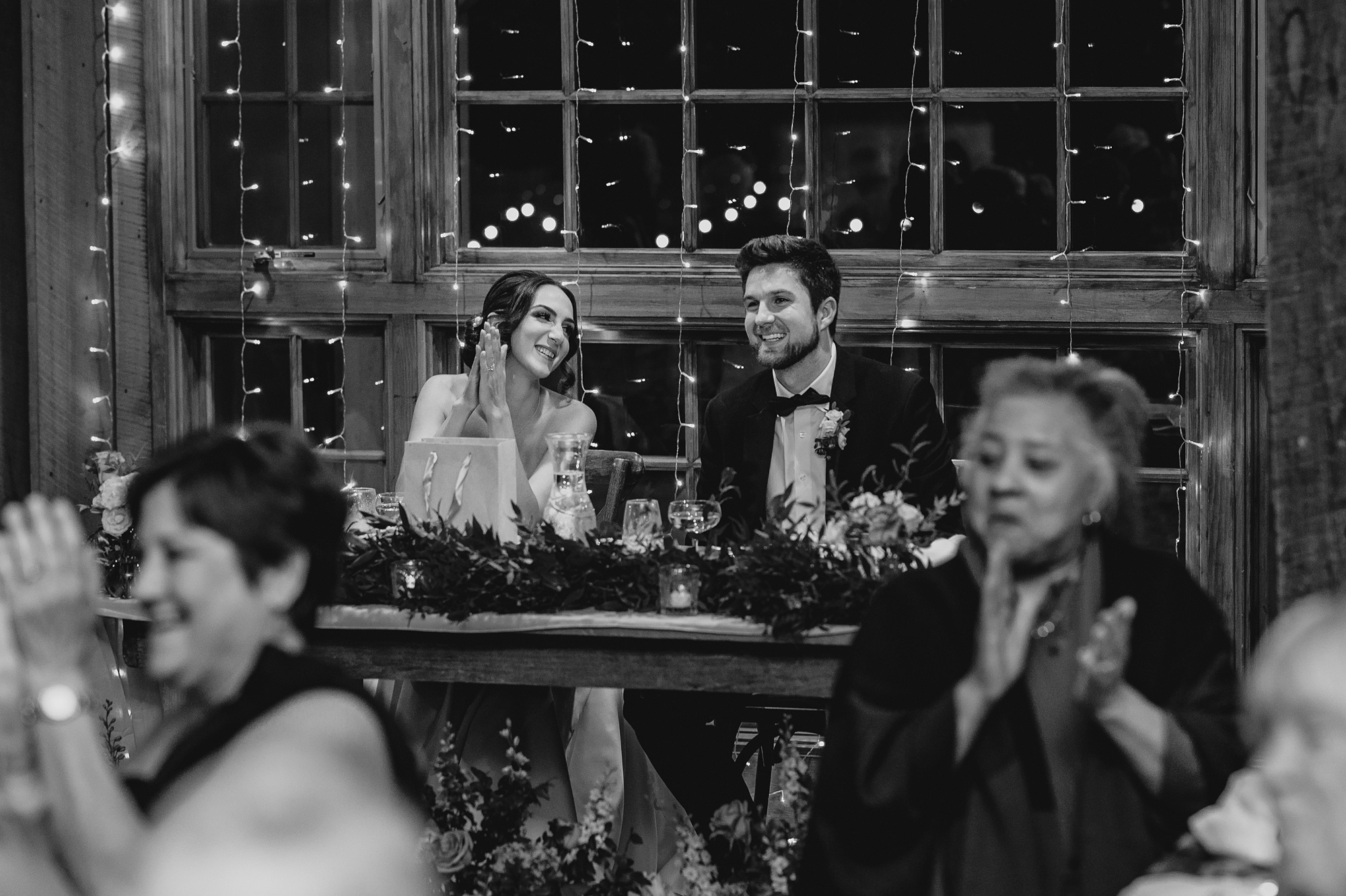 bride and groom smile watching guests during reception at Waterloo Village
